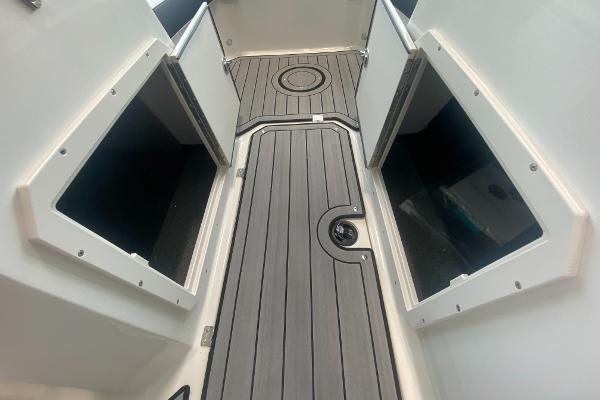 2024 Starcraft SVX 190 boat interior with open storage compartments and non-slip flooring.