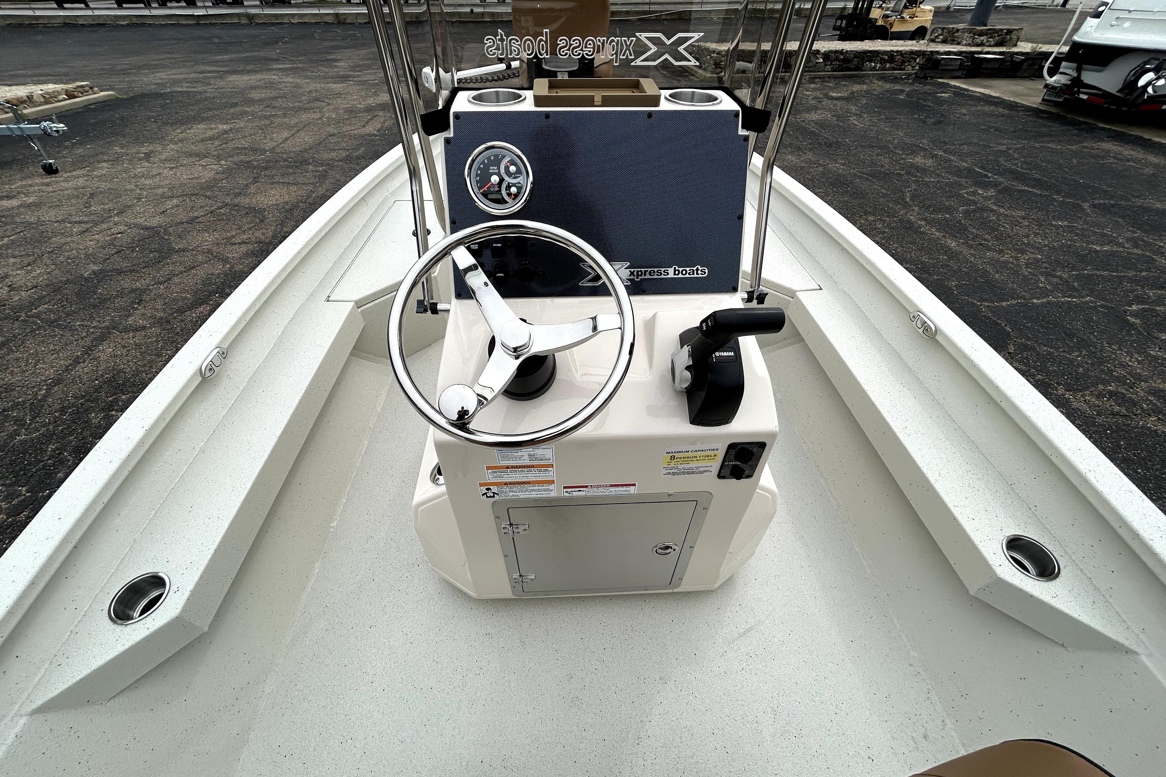 2026 Xpress H20B Bay boat interior with steering wheel and control panel.