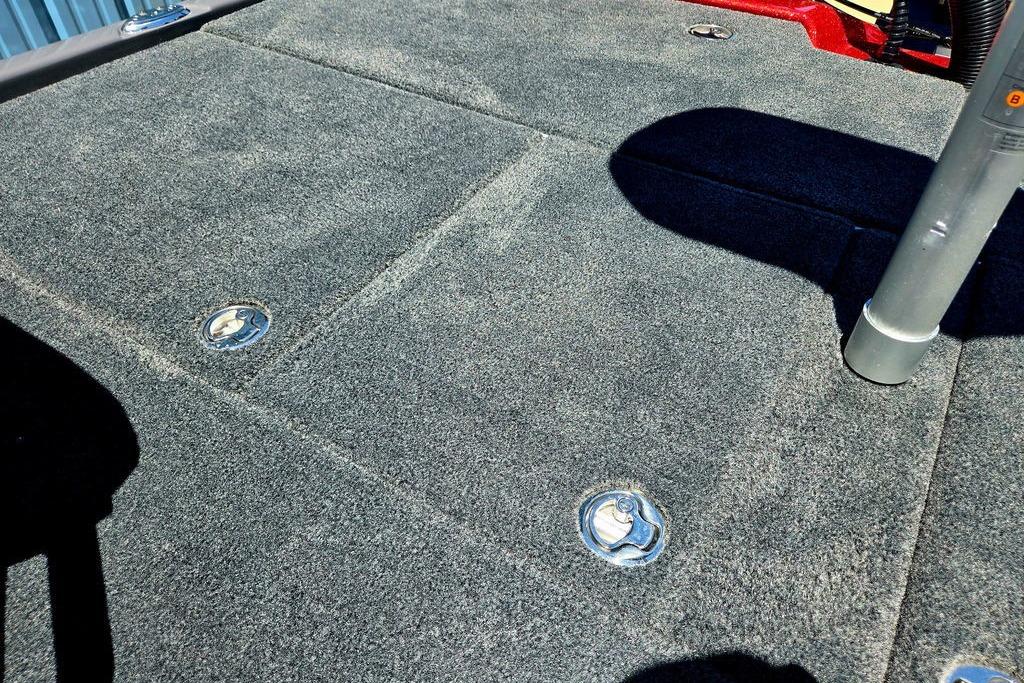 Carpeted deck of 2026 Skeeter ZXE20 boat with metal fixtures.