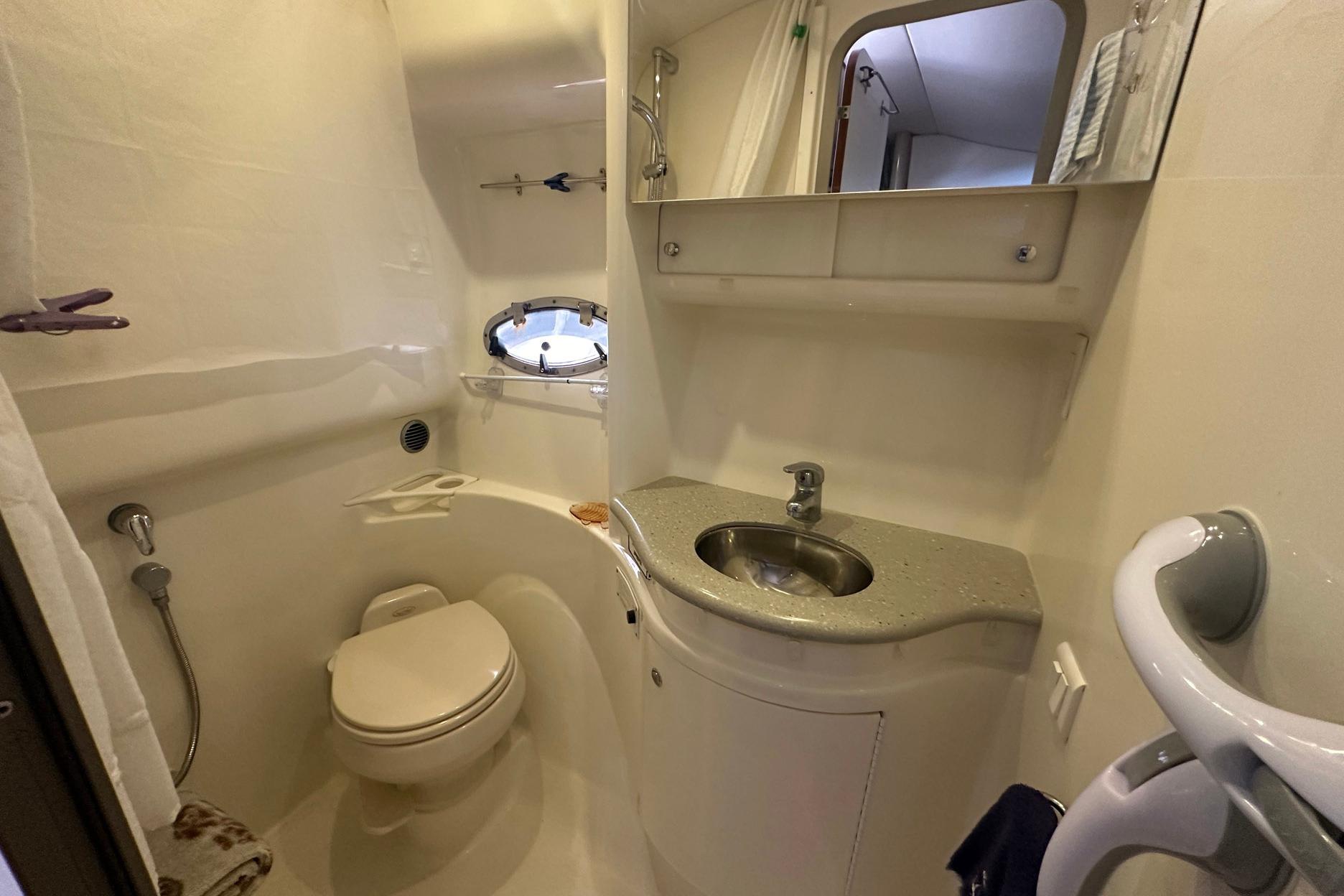 2005 Formula 37 PC yacht bathroom with sink, toilet, and porthole window.