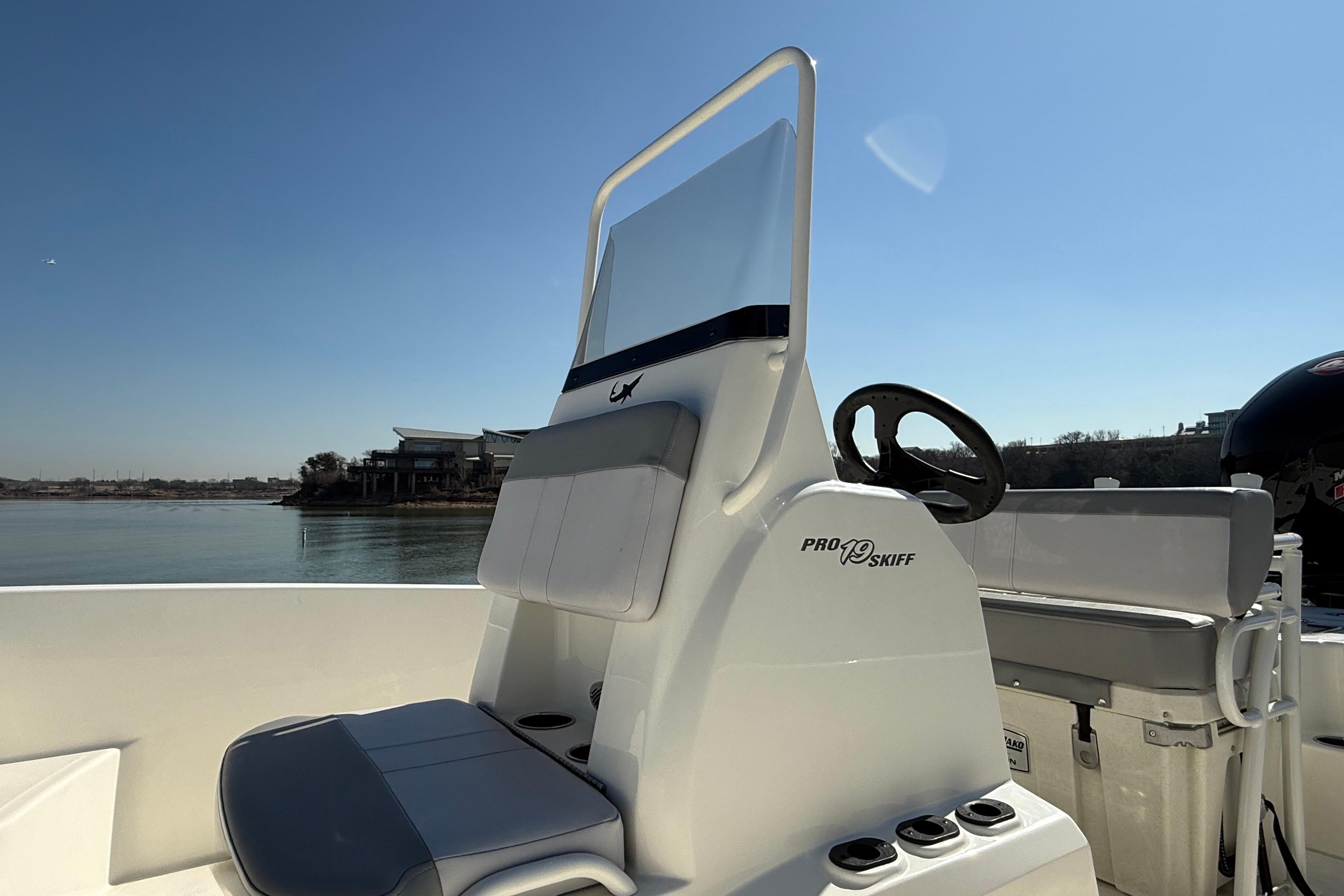 2024 Mako Pro Skiff 19 CC boat interior with steering wheel and seating.