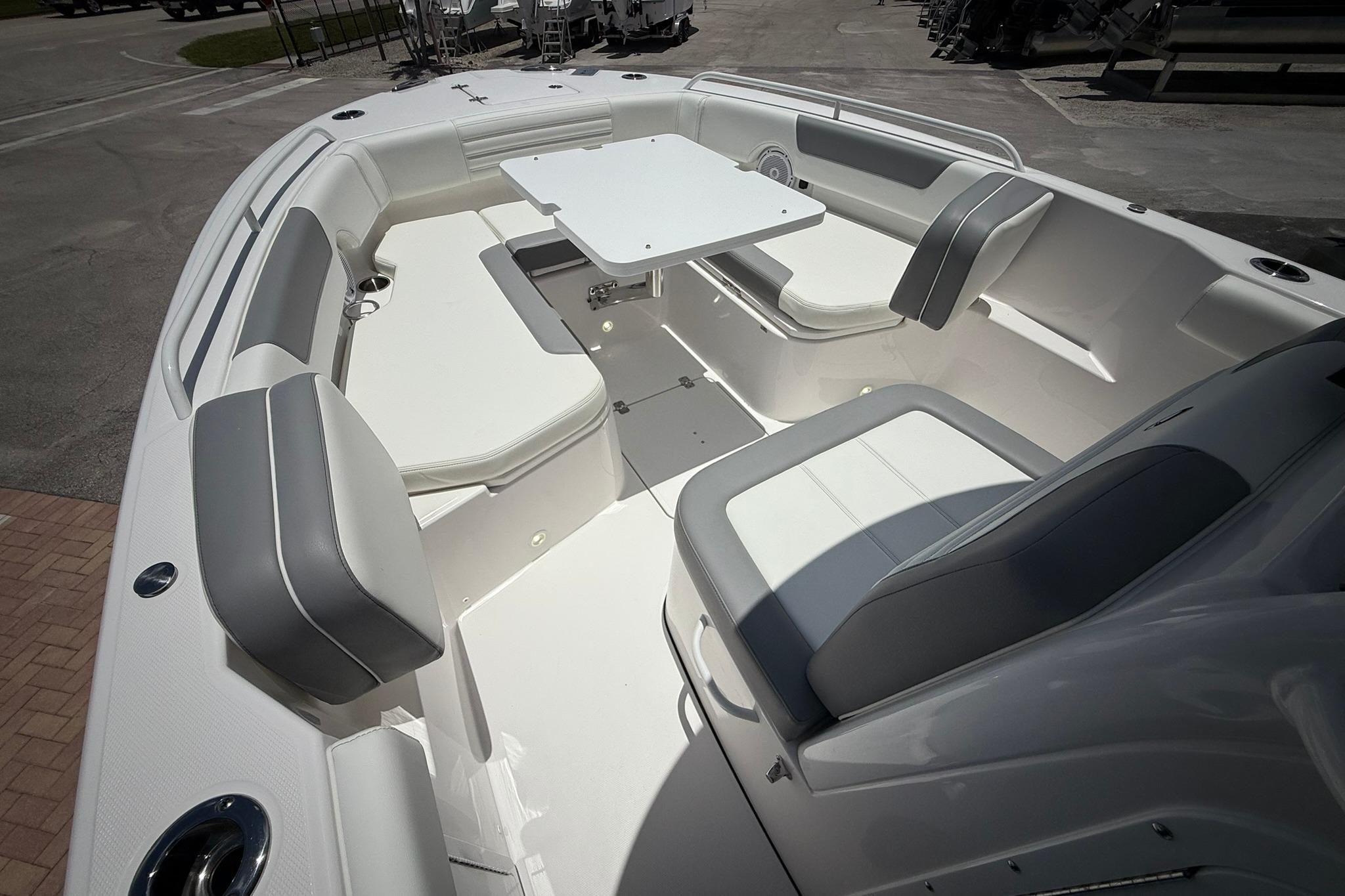 2026 Edgewater 250CC boat interior with seating and table, showcasing modern design.