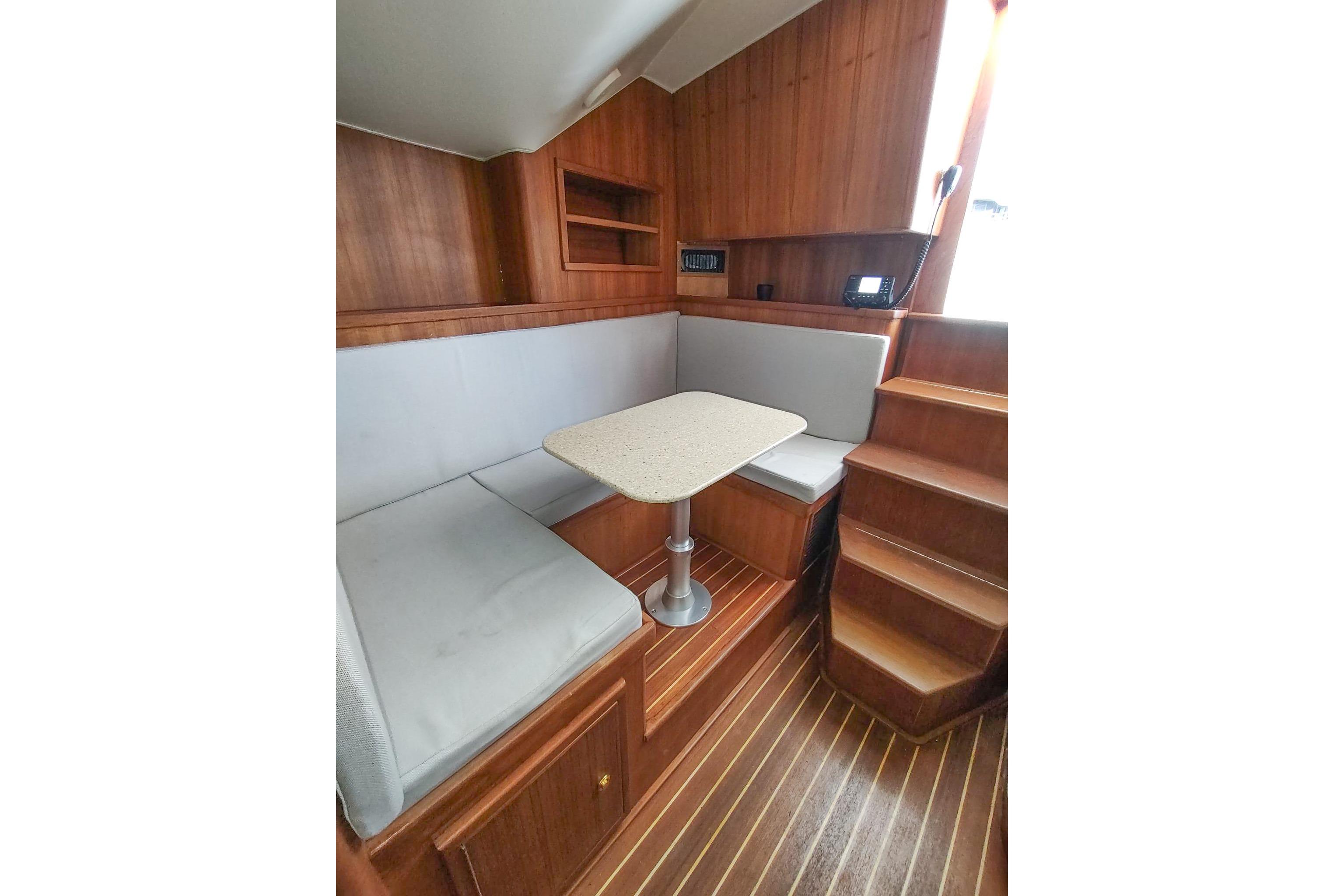2017 Out Island SeaTek 36 Express cabin interior with wooden finish and seating area.