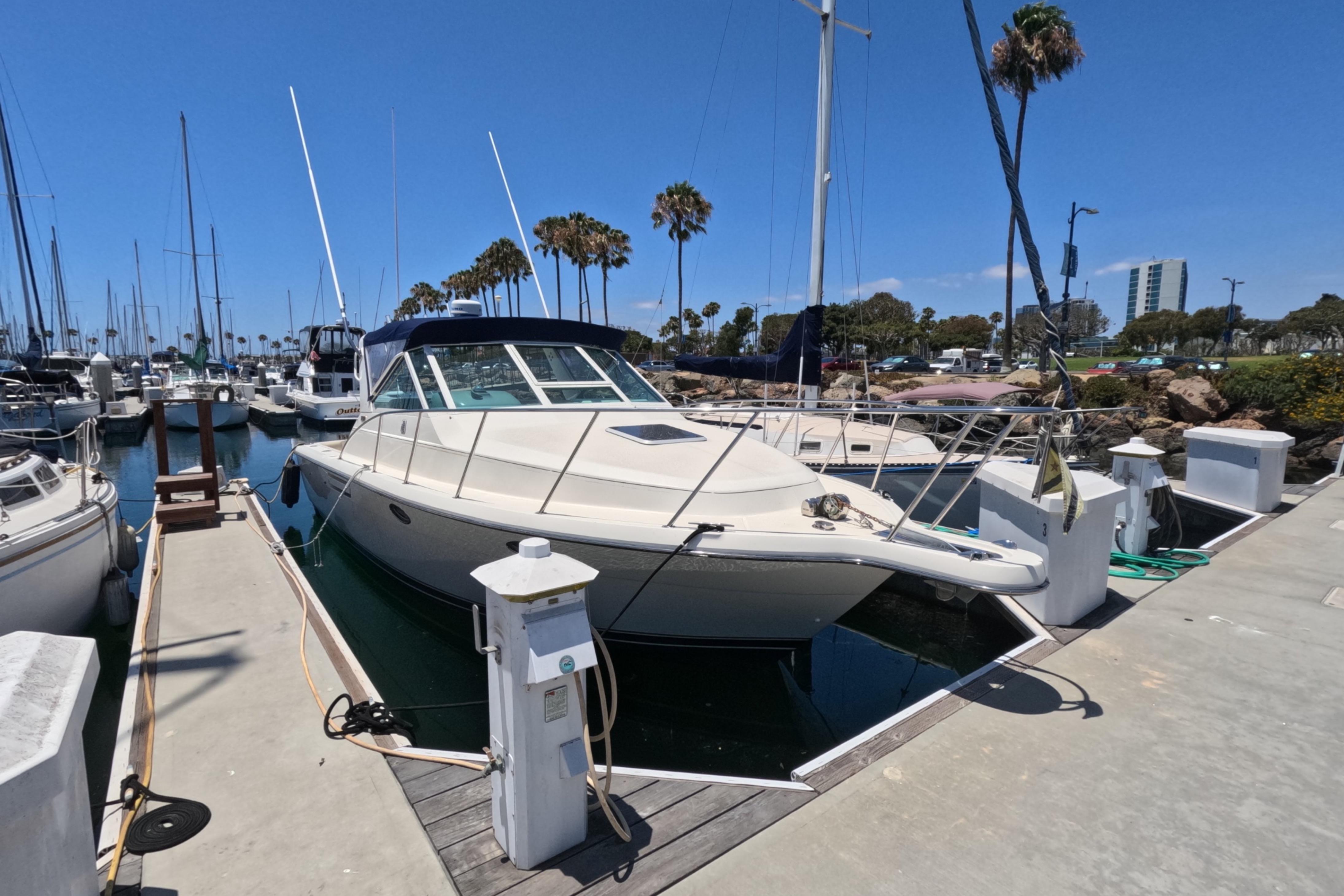 1995 Tiara Yachts 2900 Open docked at a marina under clear blue skies.