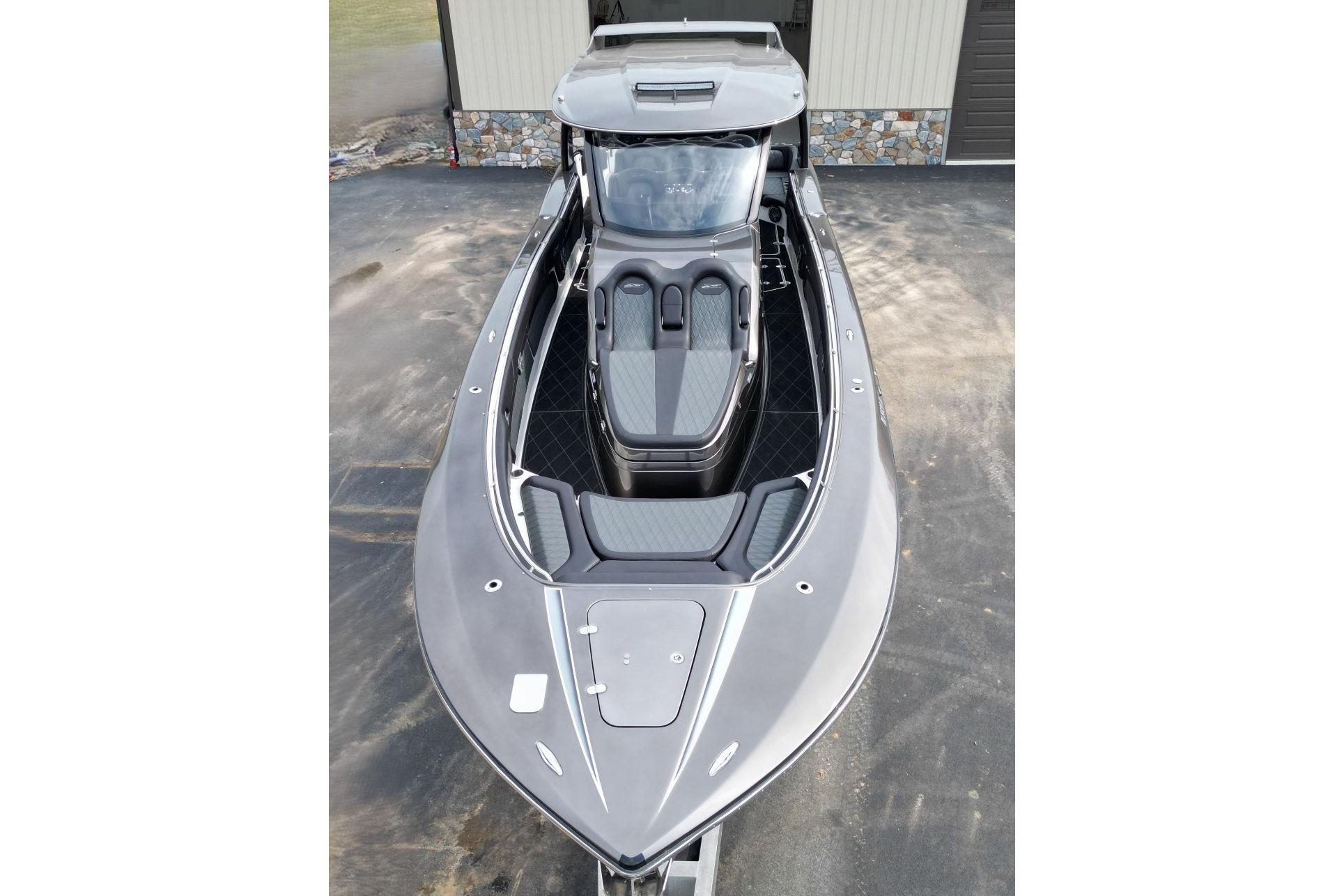 2018 MTI V42 boat with sleek design and modern seating, parked outdoors.