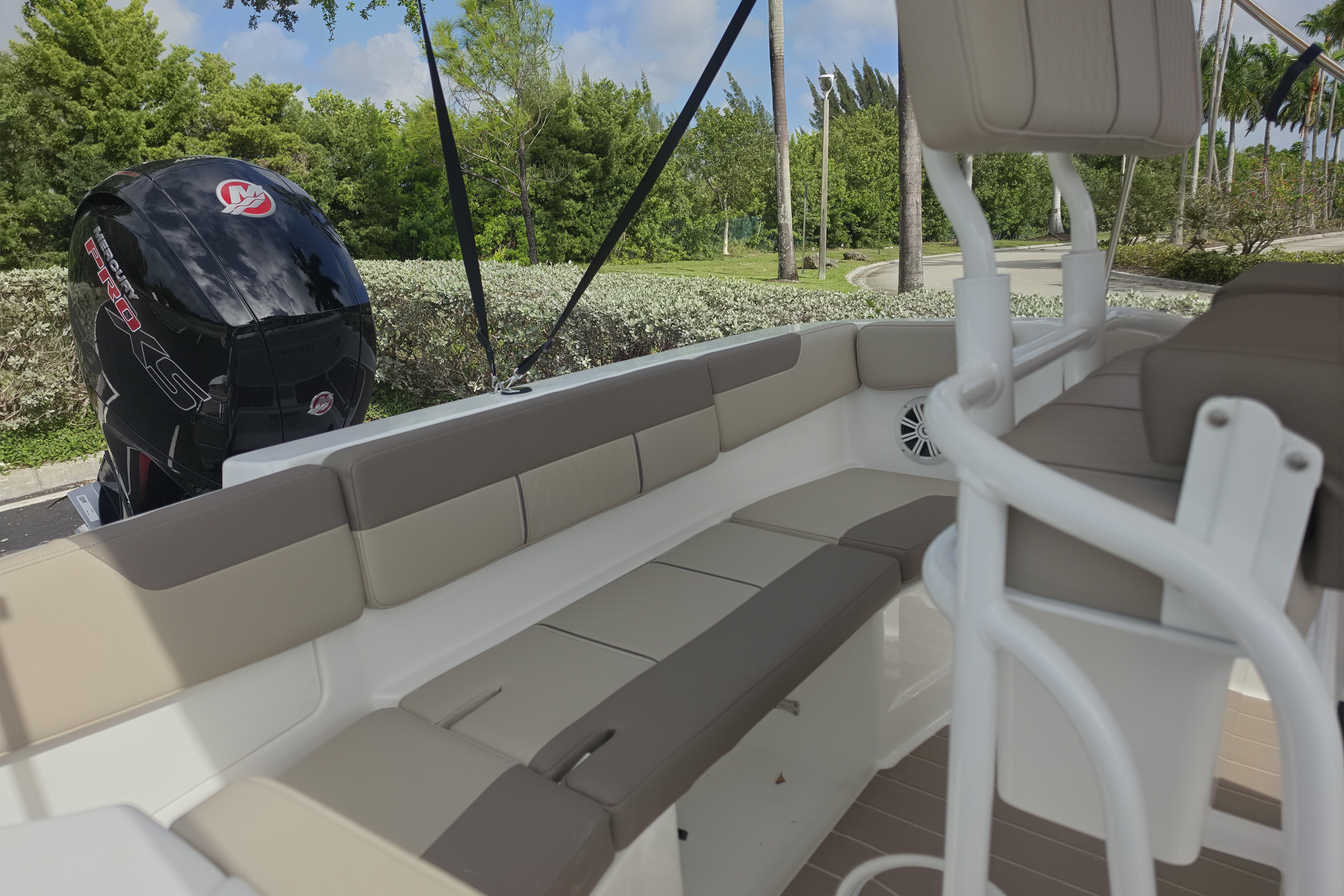 2026 Tahoe 2150 CC boat interior with seating and powerful outboard motor.