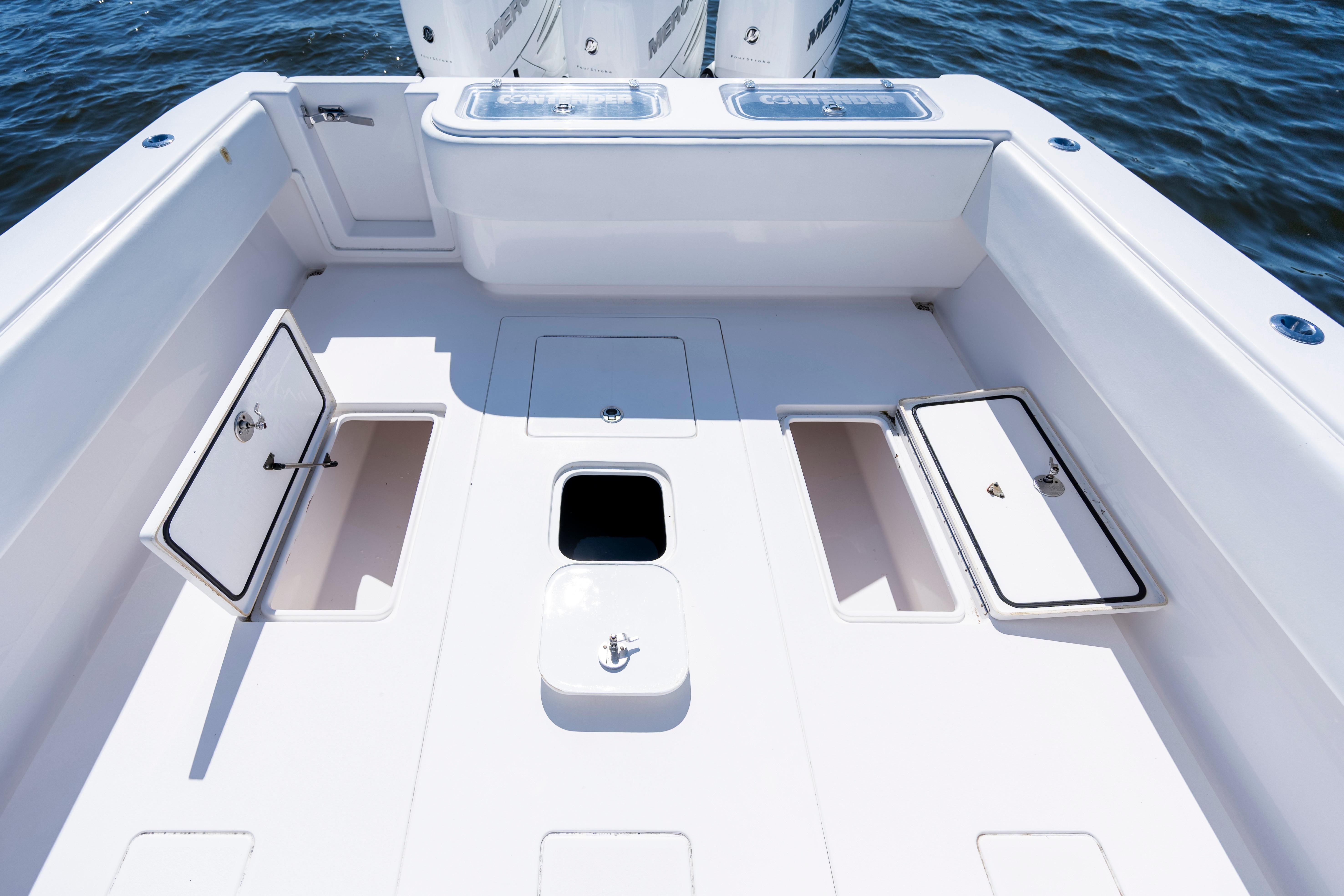2015 Contender 39 ST boat deck with storage compartments and ocean backdrop.