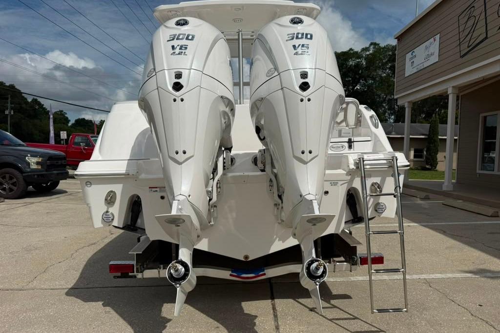 2026 Sea Fox 288 Traveler boat with dual Yamaha 300 V6 engines, parked outdoors.