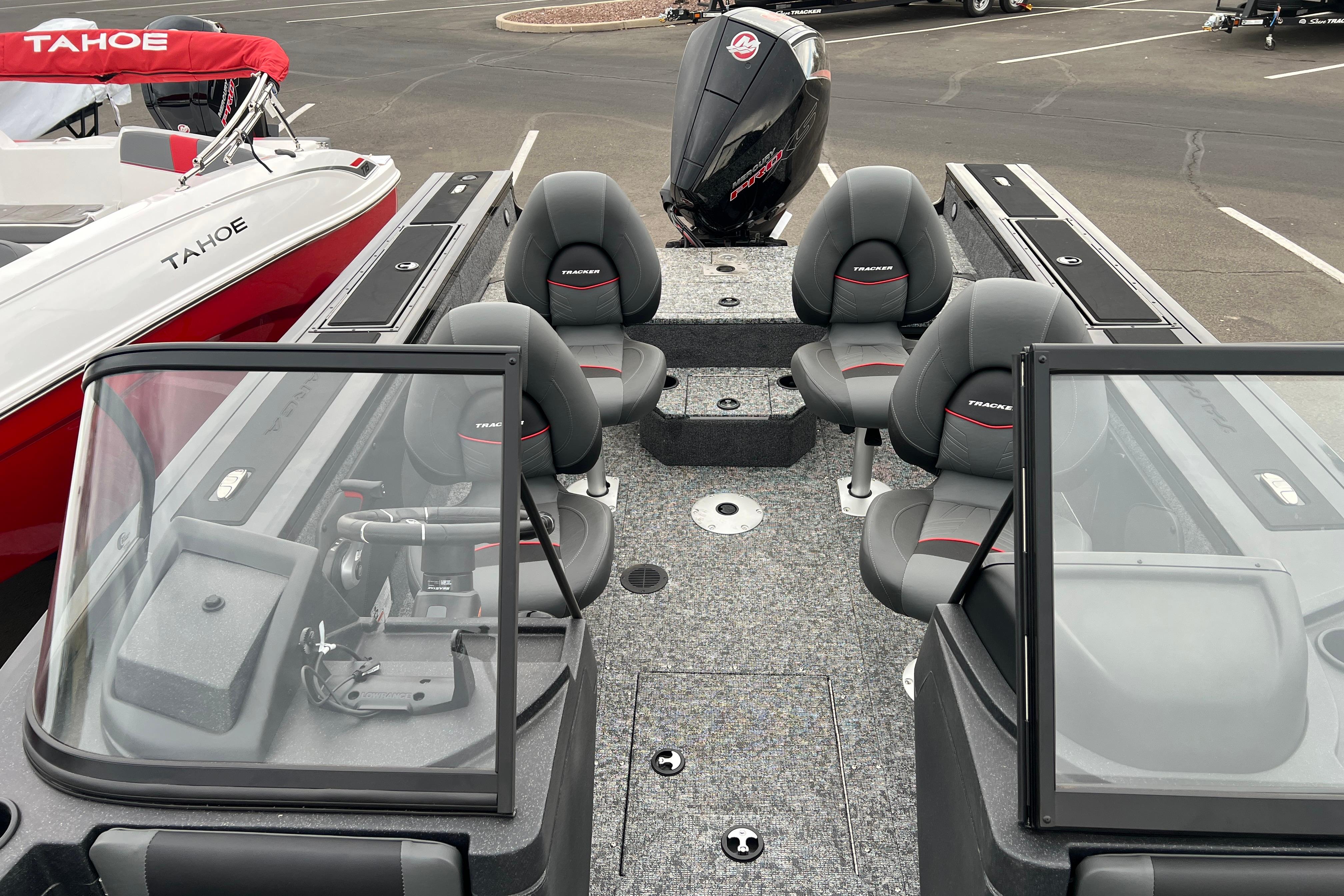 2026 Tracker Targa V-19 Combo boat interior with seating and motor, parked beside a Tahoe boat.
