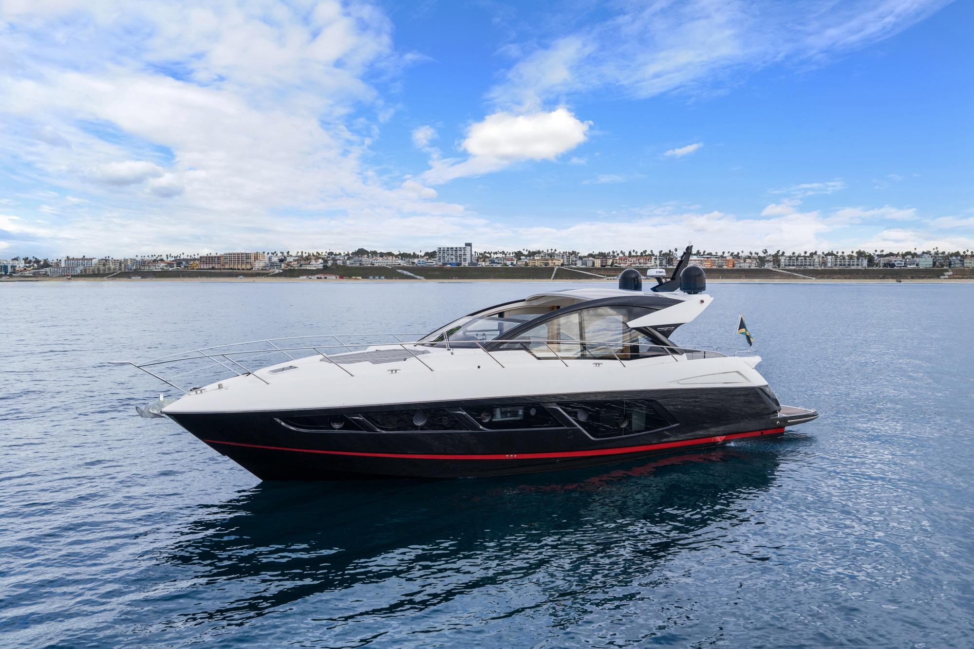 2019 Sunseeker Predator 57 yacht on calm waters under a blue sky.