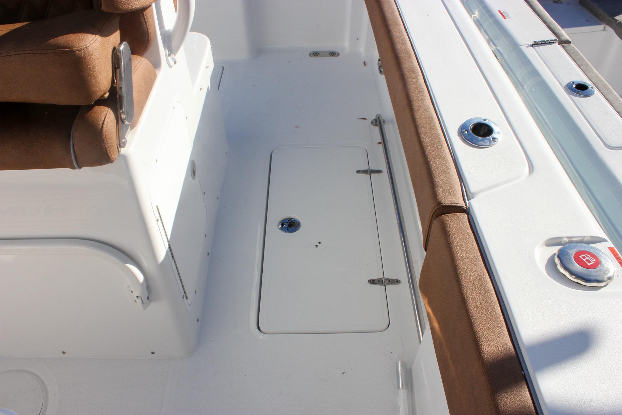 2026 Sea Hunt Ultra 285 SE boat interior with brown seating and storage compartment.