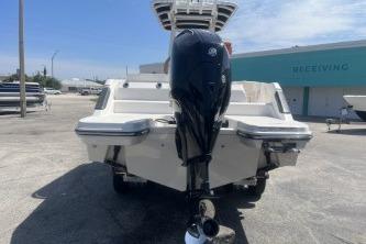 2023 Trophy T24 CC boat with powerful outboard motor, parked outdoors.