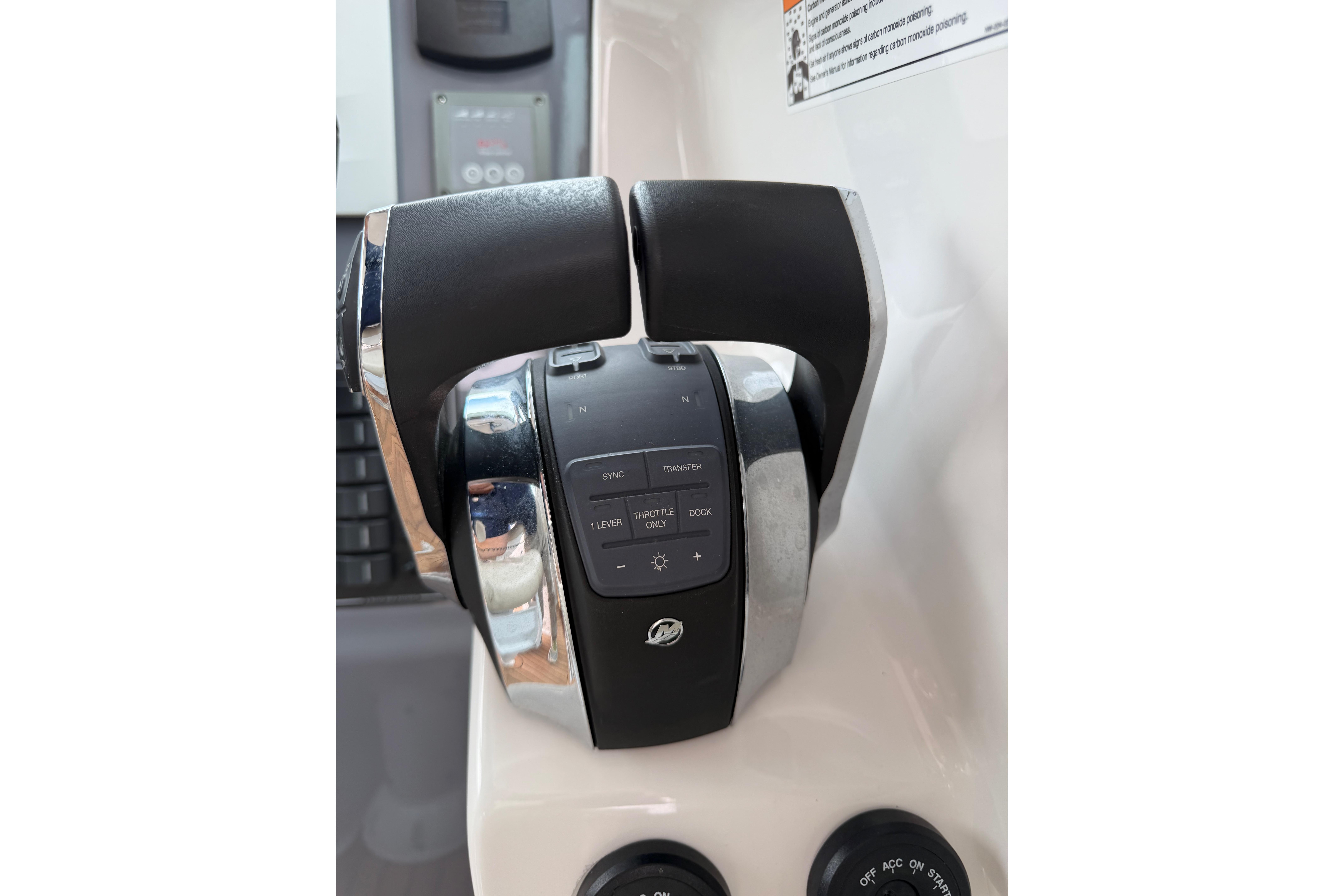 Throttle controls of a 2016 Protector Targa 30 boat, featuring dual levers and control buttons.