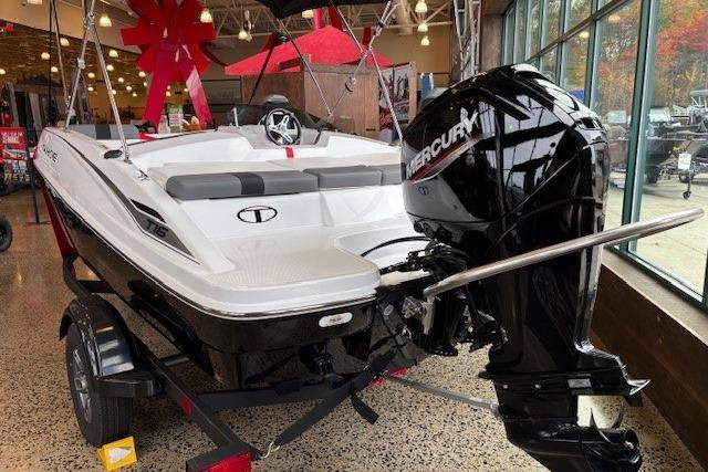 2026 Tahoe T16 boat with Mercury engine displayed indoors, featuring sleek design and modern features.