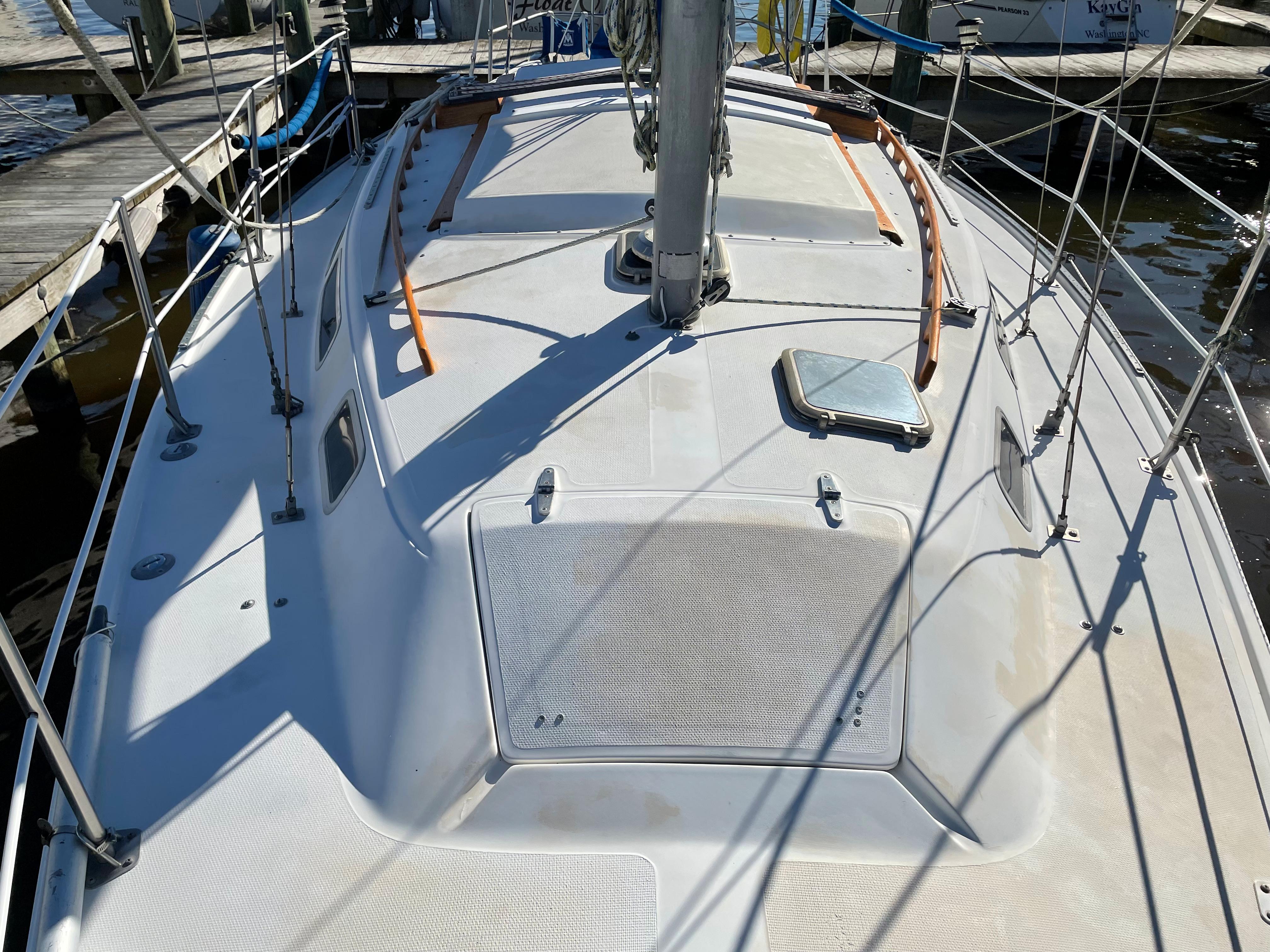 1982 Catalina 30 sailboat deck view at marina, showcasing mast and rigging.