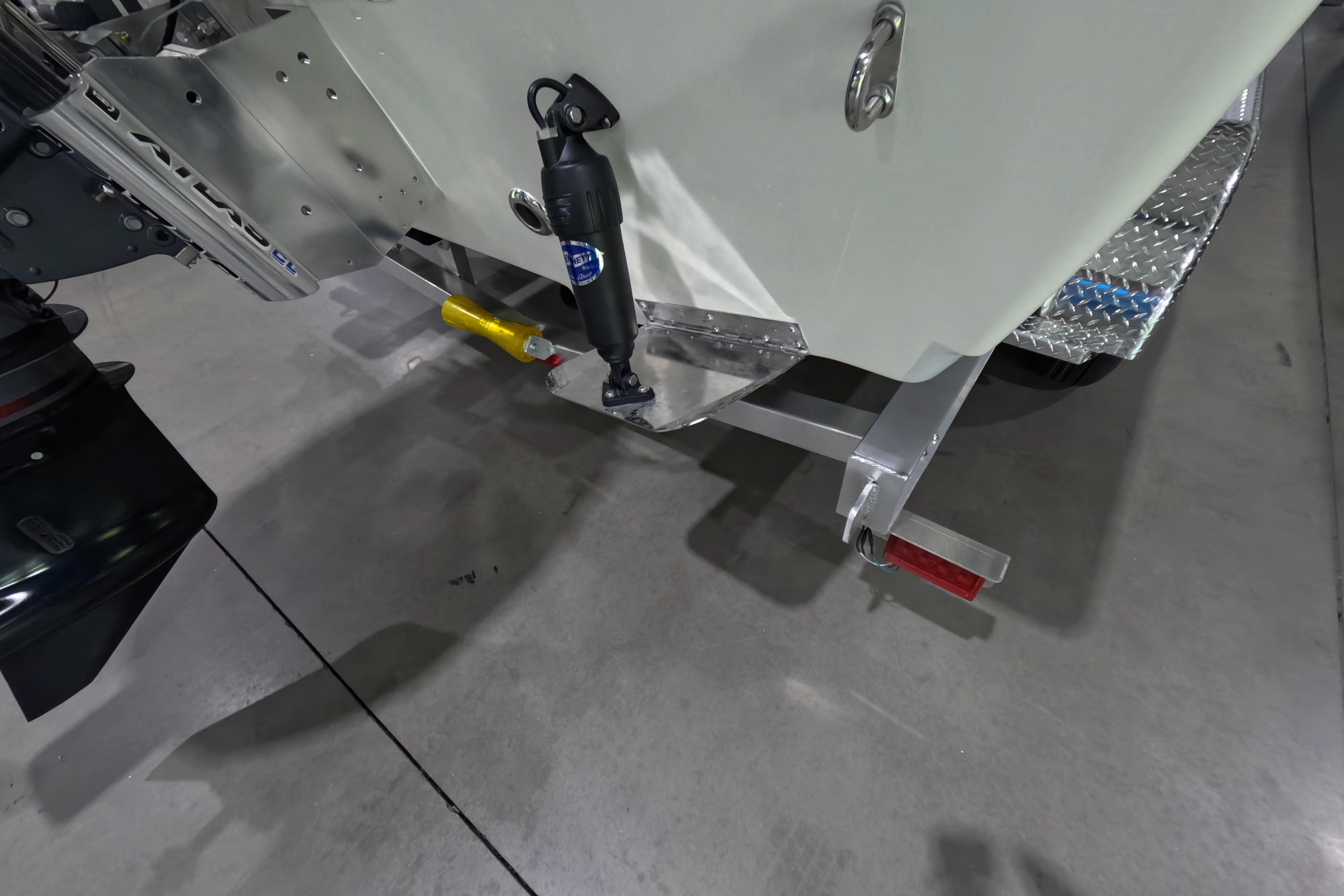 2026 Skeeter SX221 boat trailer hitch and motor detail in a garage setting.