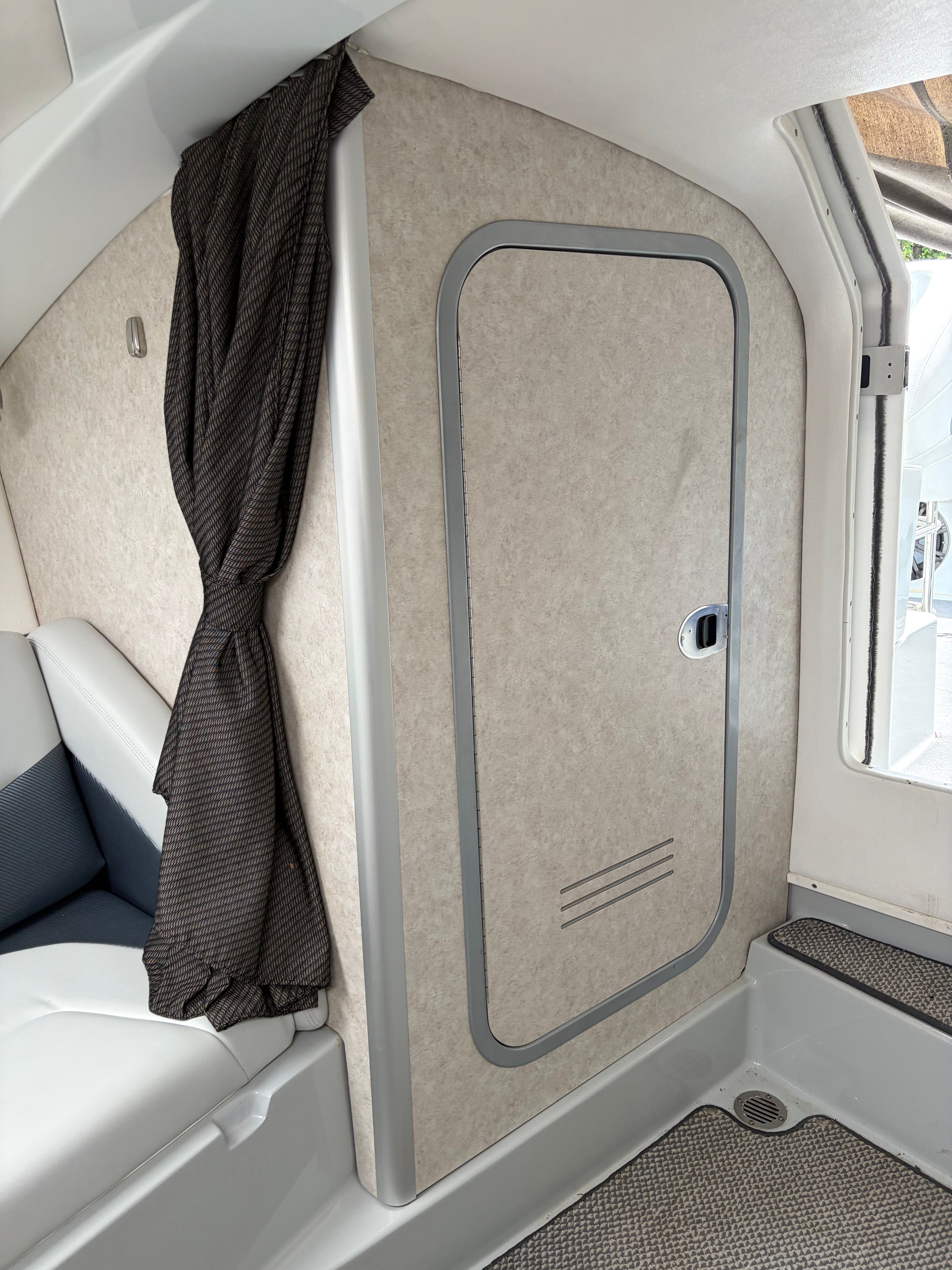 Interior of a 2007 Baja 30 Outlaw with curtain and door.