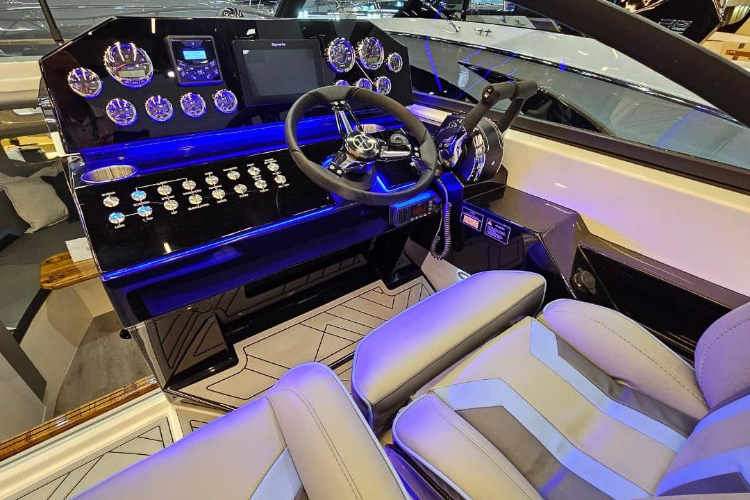 Luxurious 2026 Hanover 327 boat cockpit with modern controls and illuminated dashboard.