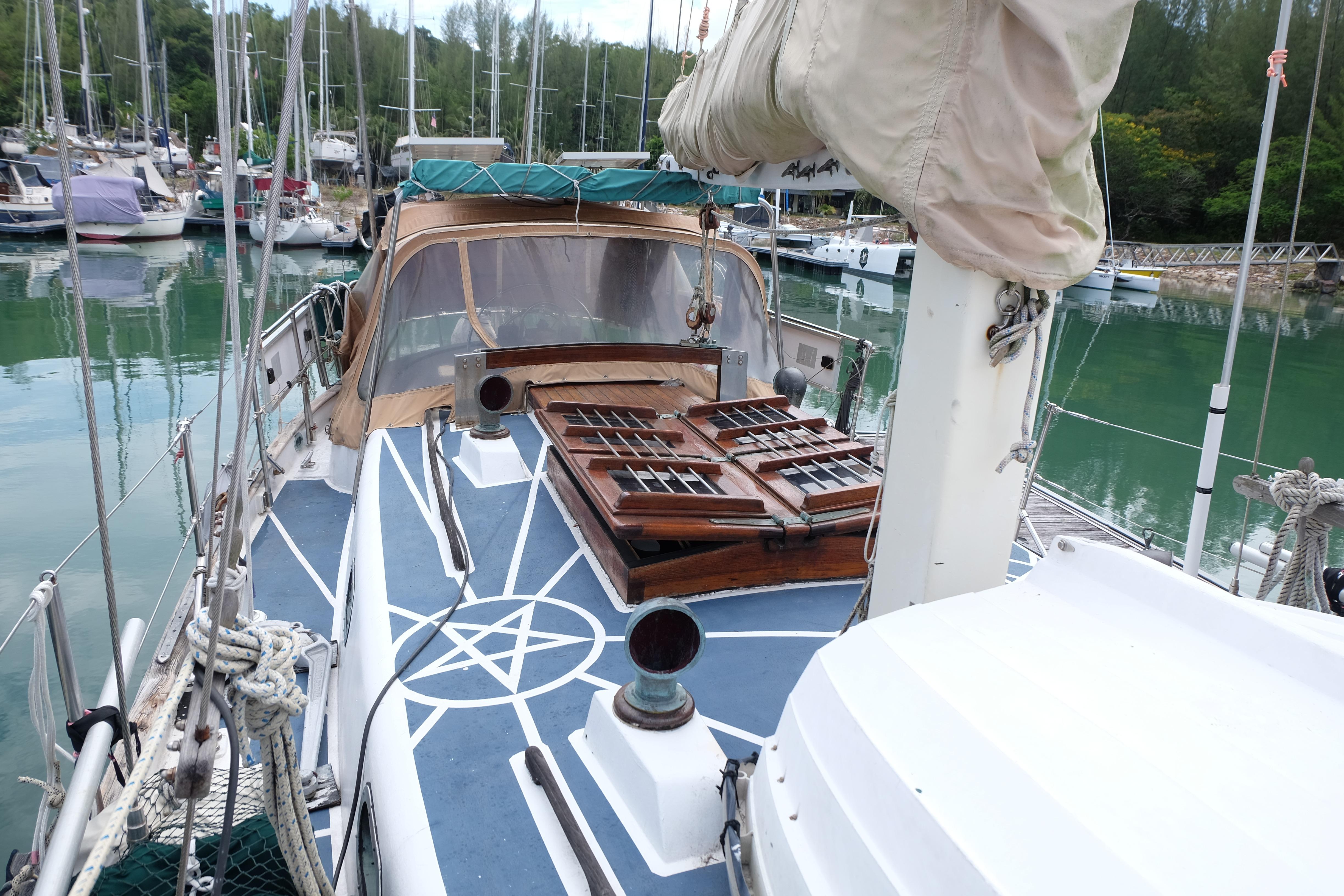 1979 Westwind 35 sailboat docked in a serene marina with lush greenery.