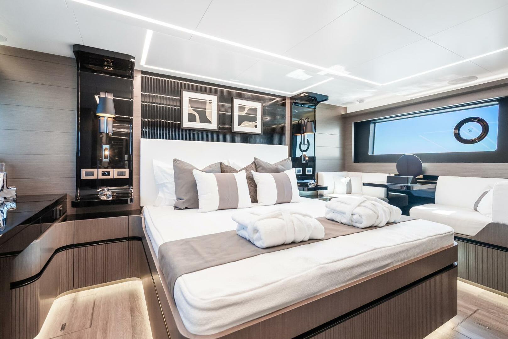 Luxurious bedroom interior of 2025 Pearl 63 yacht with modern decor and elegant furnishings.