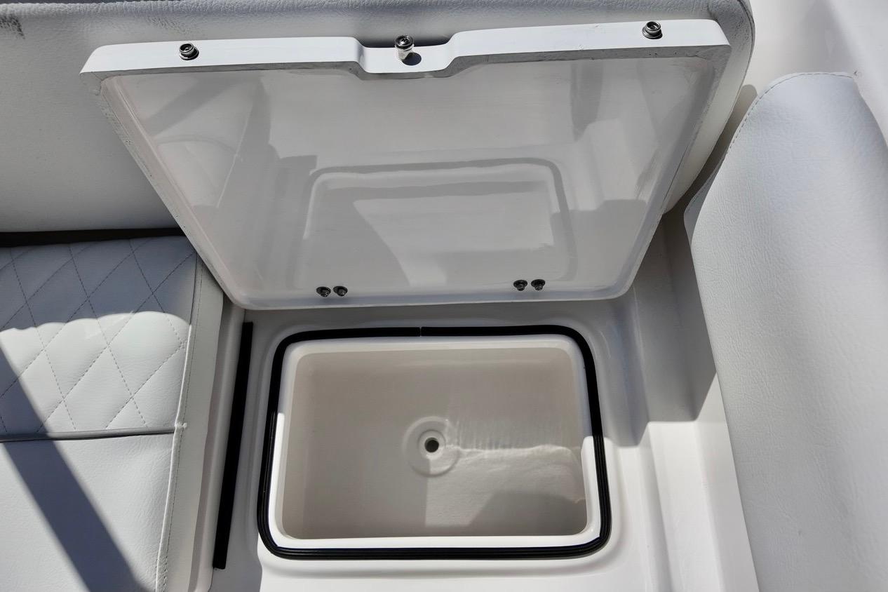 Open storage compartment on 2026 Sea Fox 228 Traveler boat, featuring cushioned seating.