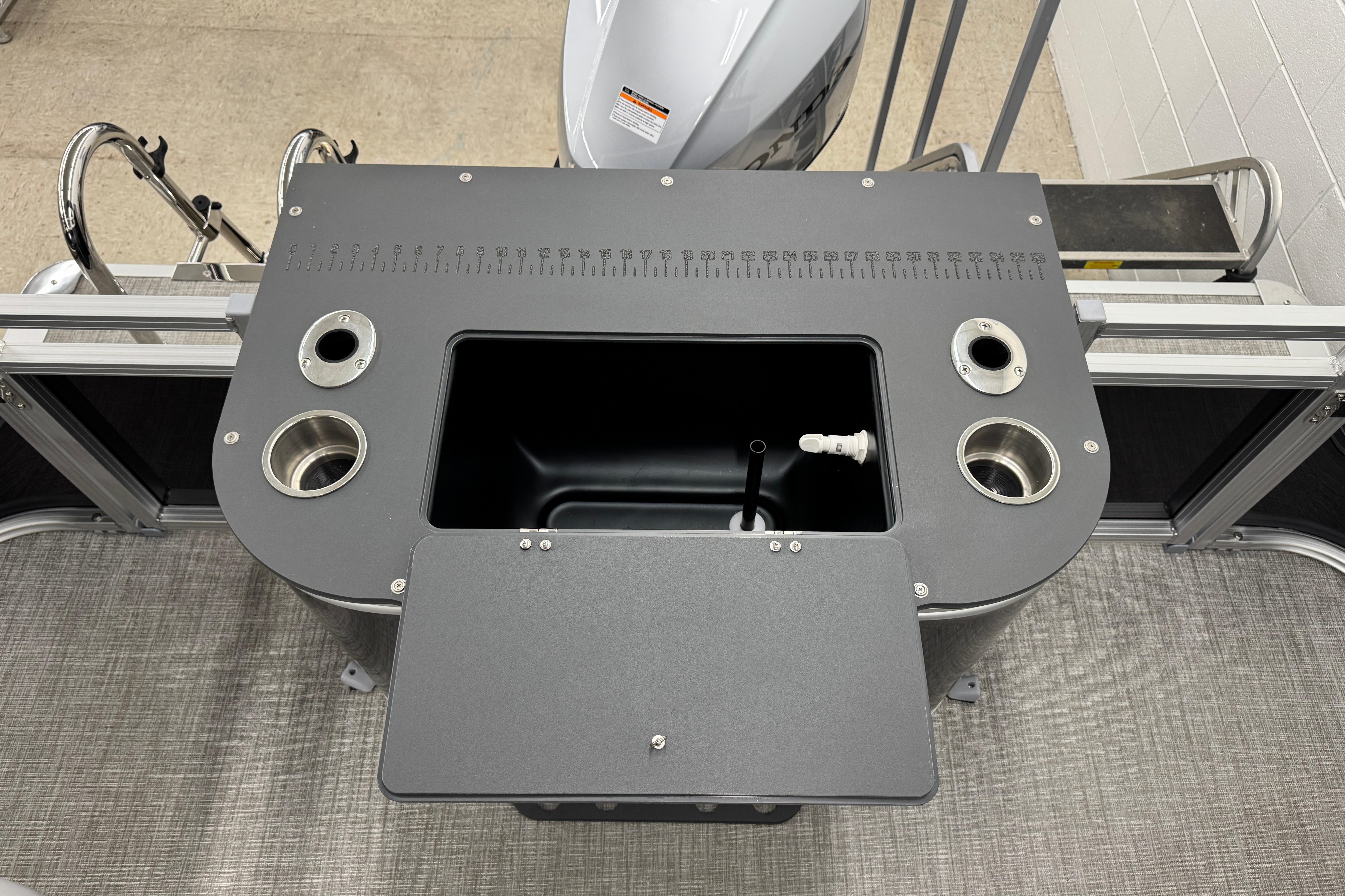 2026 Avalon Ventue 85 RF boat console with cup holders and storage compartment.