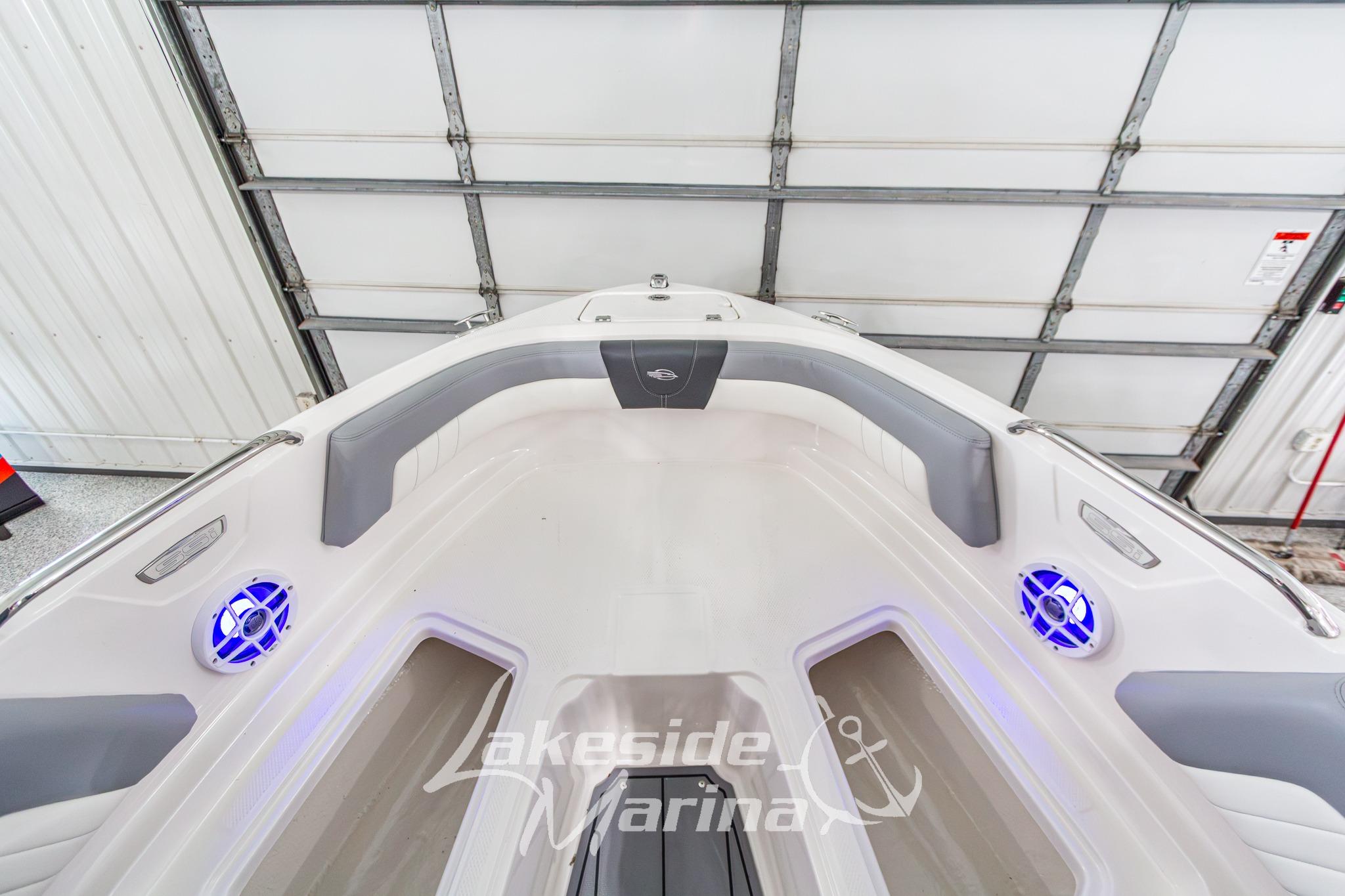 2022 Chaparral 21 SSi boat interior with gray seating and blue LED speakers.