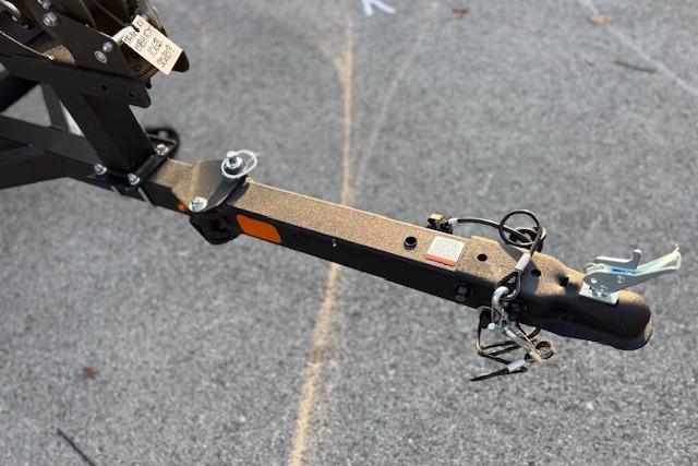 Trailer hitch of a 2026 Tahoe T16 on asphalt surface.