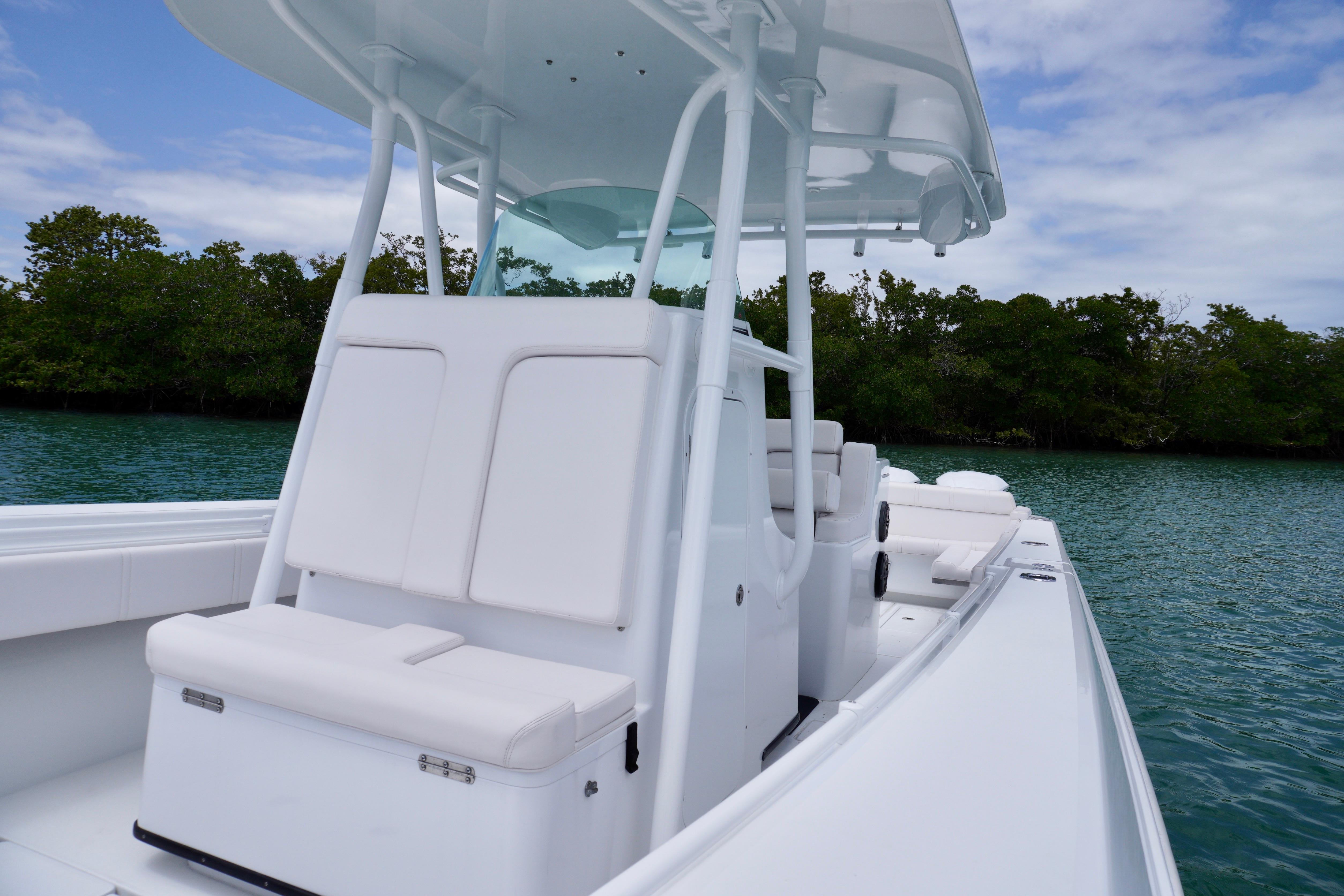 2013 Contender 35 LS boat with sleek white seating, cruising on calm waters.