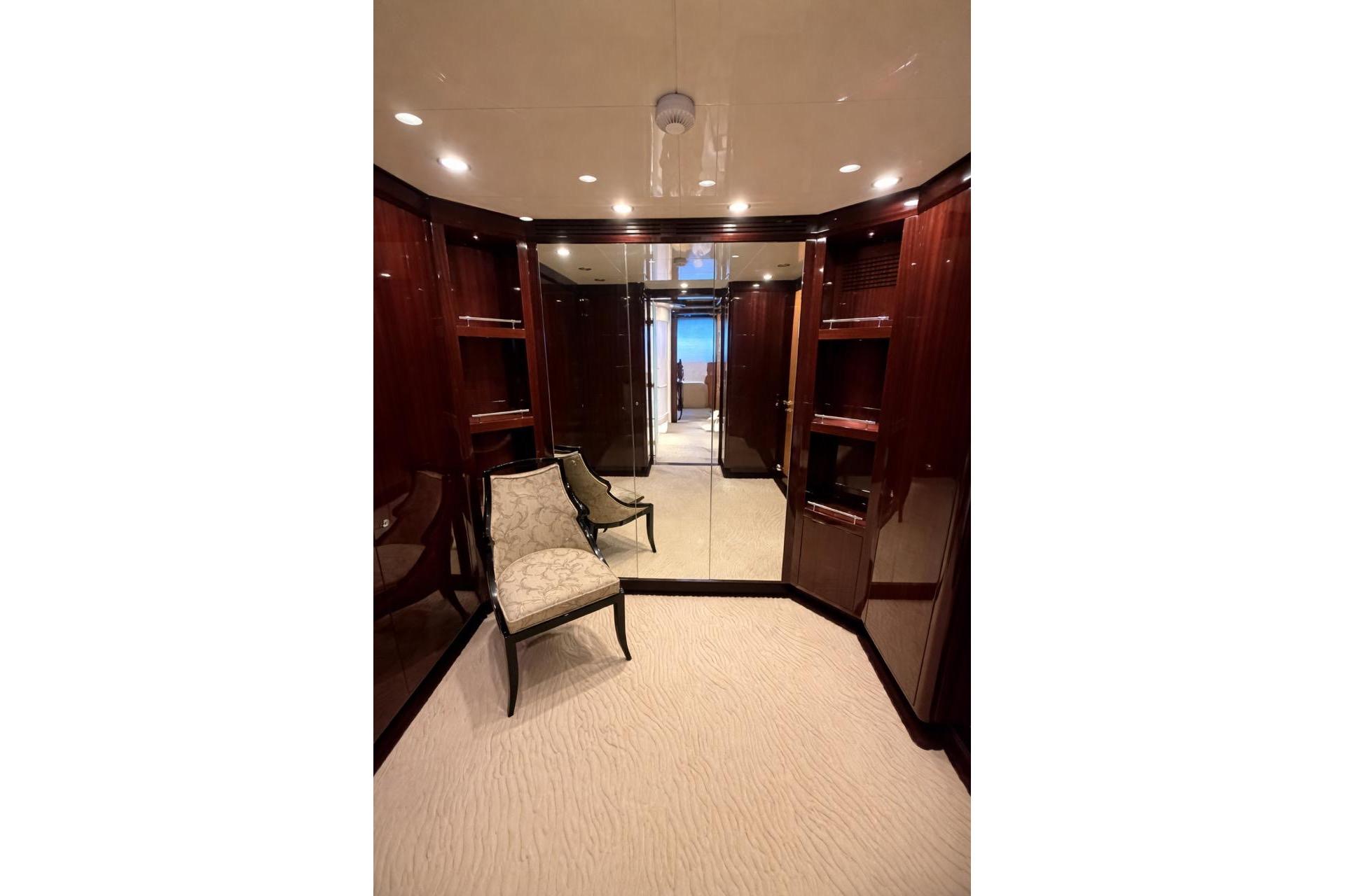 Luxurious yacht interior with elegant wood paneling and plush seating, Riviera 2010 model.