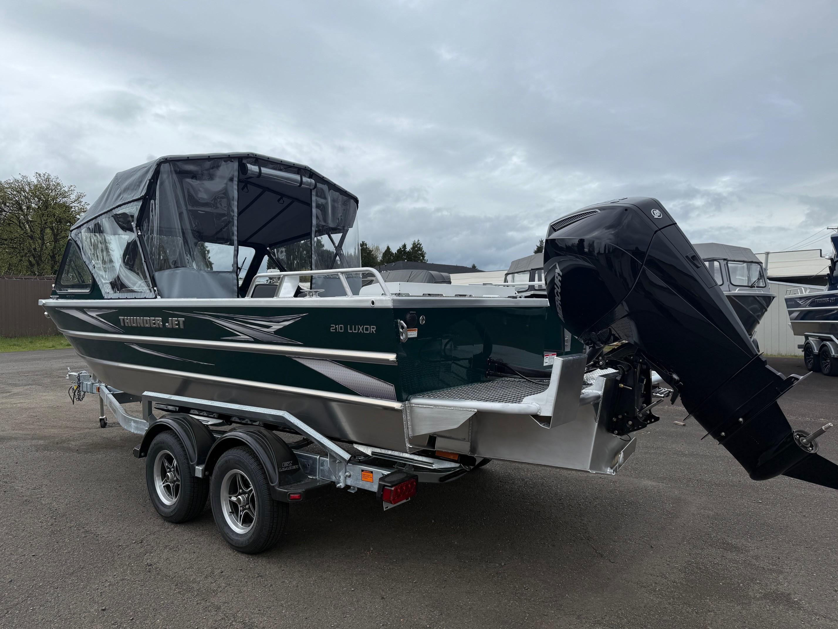 2025 Thunder Jet 210 Luxor boat on trailer, featuring a sleek design and powerful outboard motor.