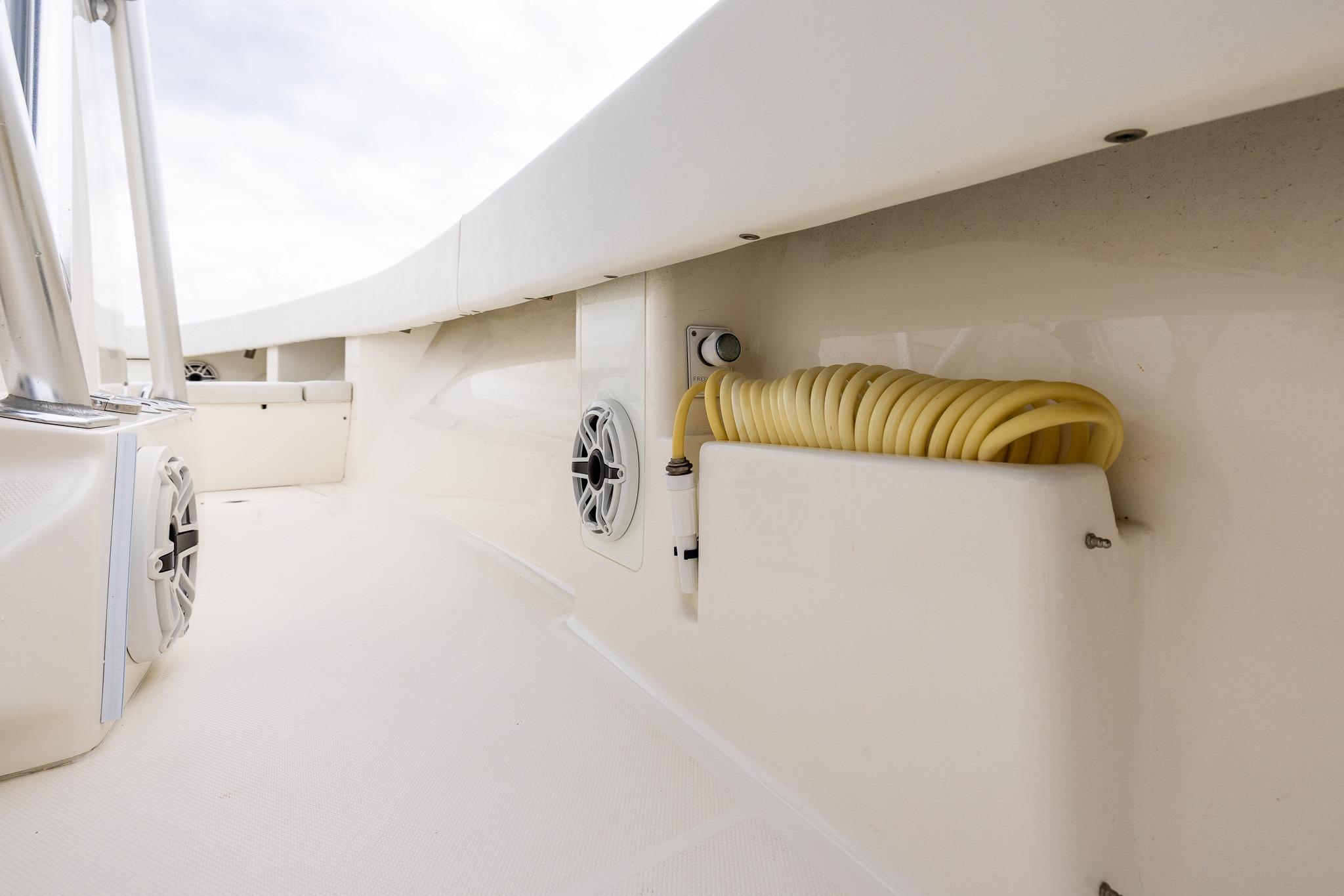 2019 SeaVee 322Z boat interior with speakers and coiled hose on deck.