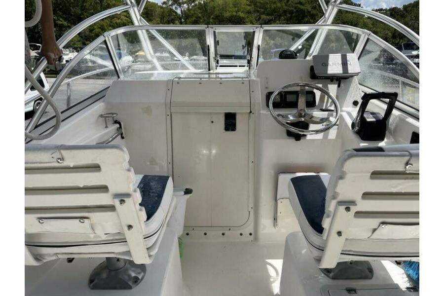 2006 Century 2400 Walk-Around boat interior with steering wheel and seating.