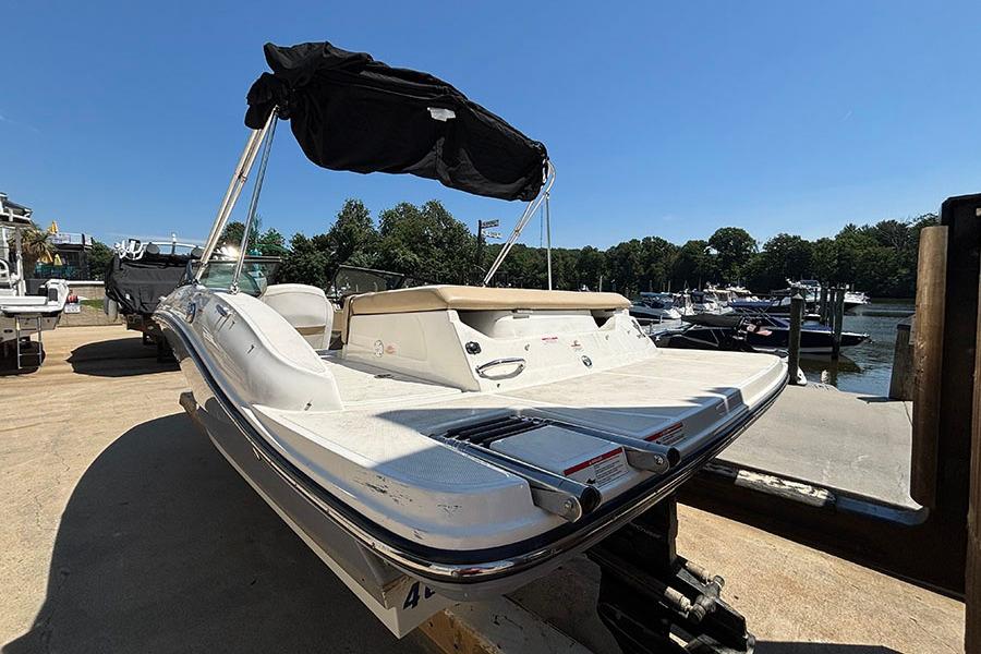 2018 Sea Ray SPX 190 boat docked, featuring a sleek design and black canopy.