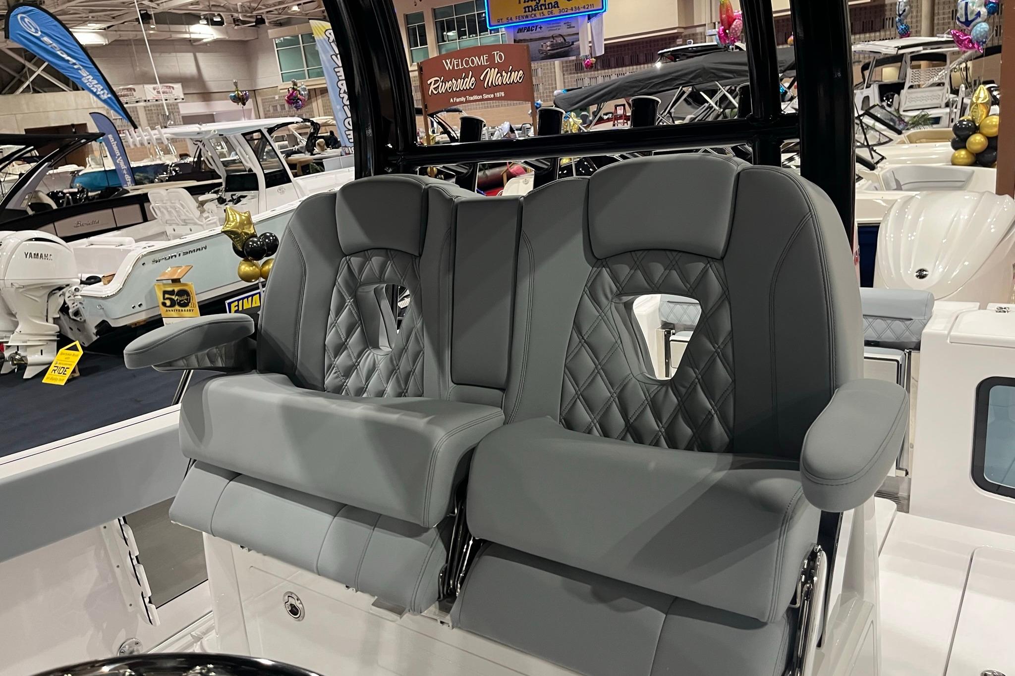 2026 Sportsman Open 302 Center Console with luxurious gray seating at a boat show.