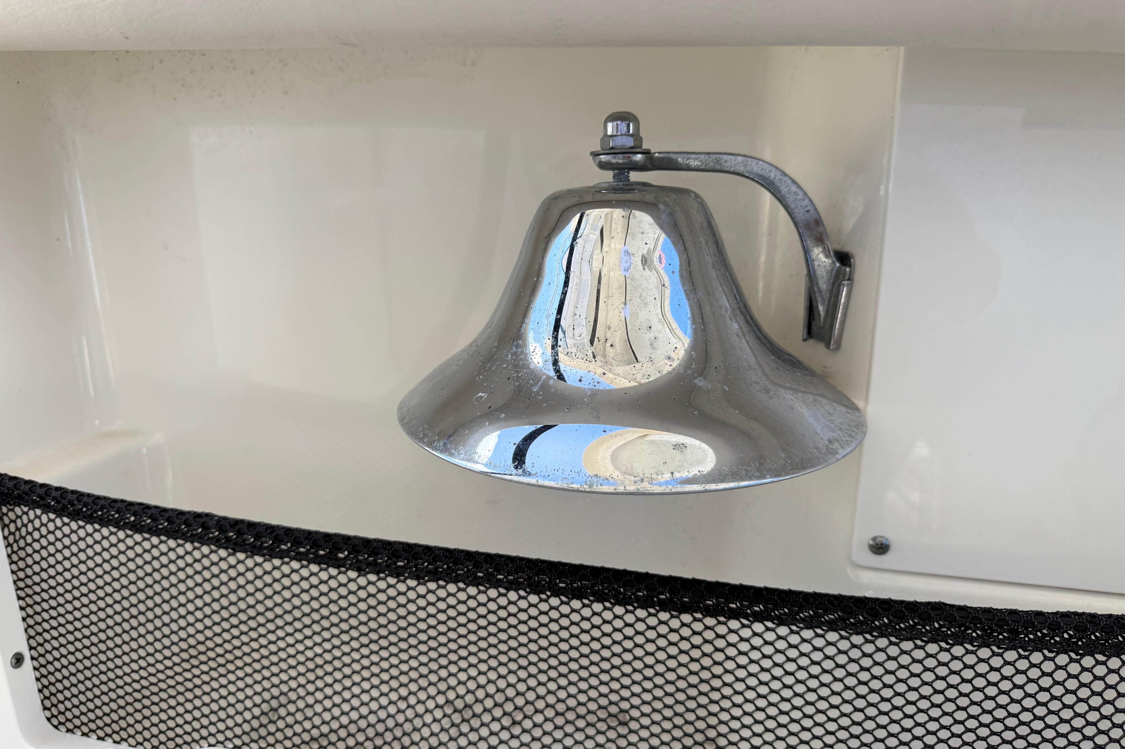 Chrome bell on 2017 Boston Whaler 420 Outrage boat, mounted on white surface.