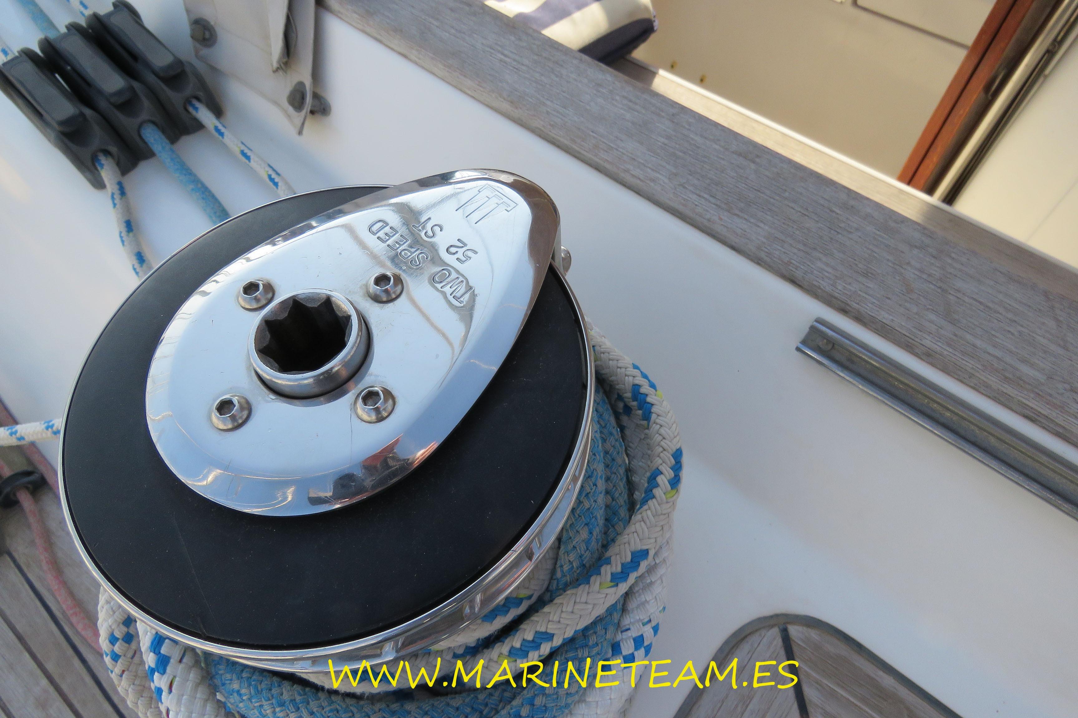 Winch on 2002 Najad 373 sailboat deck with ropes and cleats.