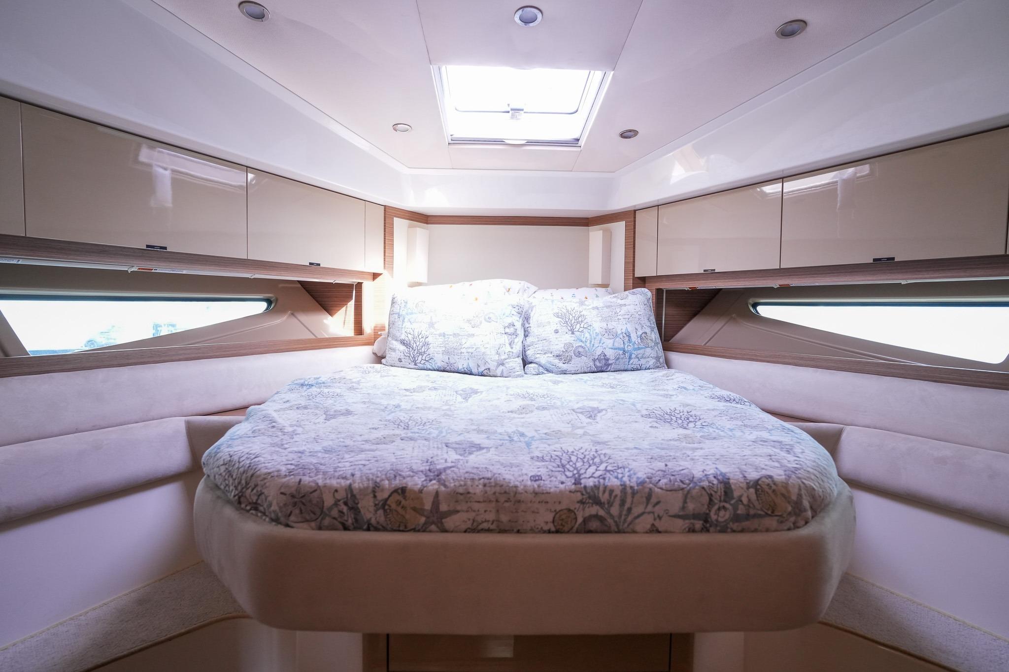 Luxurious interior cabin of 2015 Azimut Atlantis 50 yacht with cozy bed and elegant design.