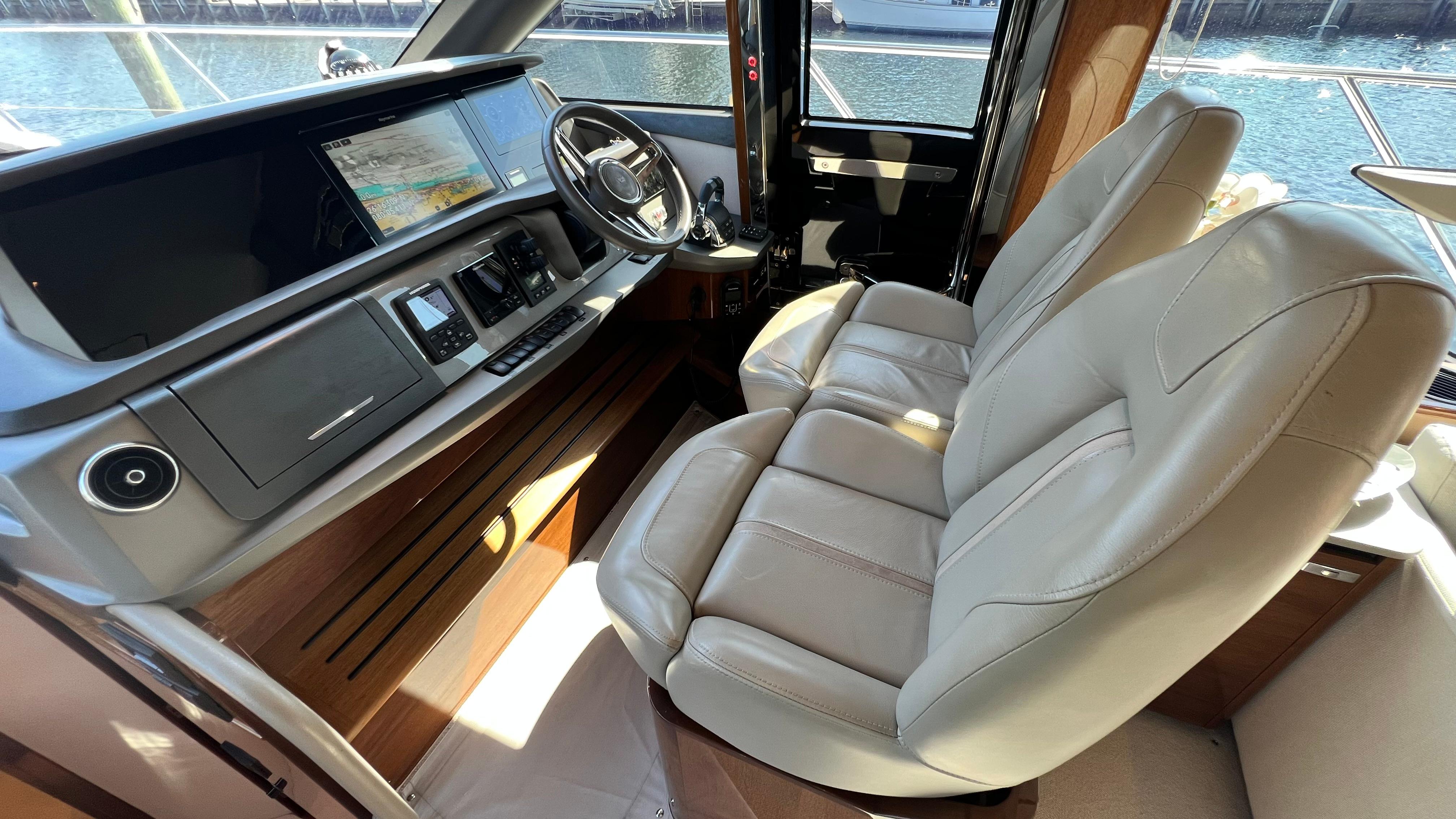 Luxurious 2019 Princess F62 yacht cockpit with leather seats and advanced navigation system.
