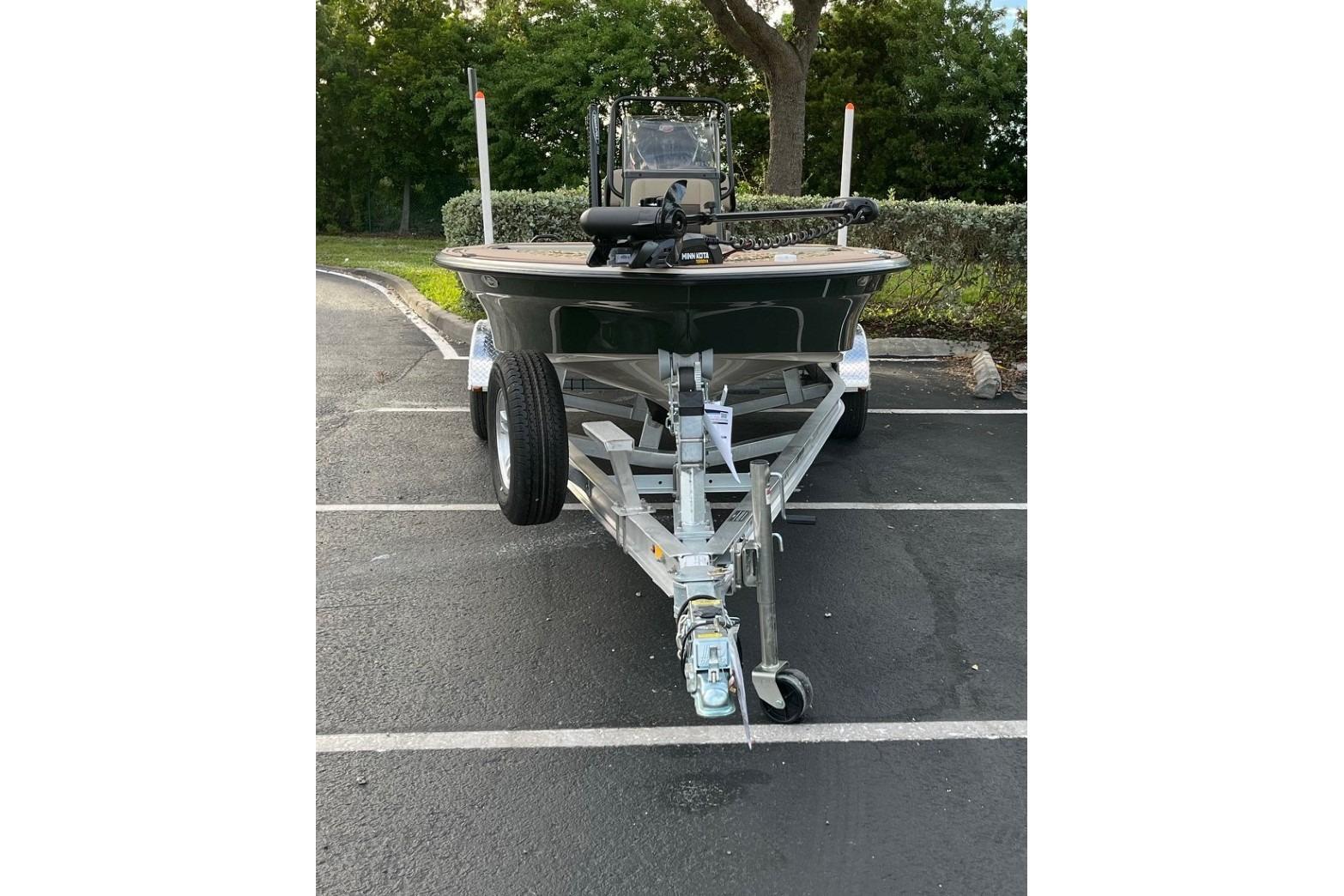 2026 Mako 18 Pro Skiff Backwater Edition on trailer in parking lot.