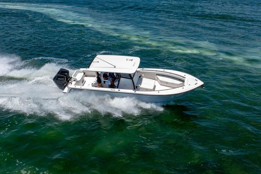 2027 Reef Runner 340 boat cruising swiftly on open water.