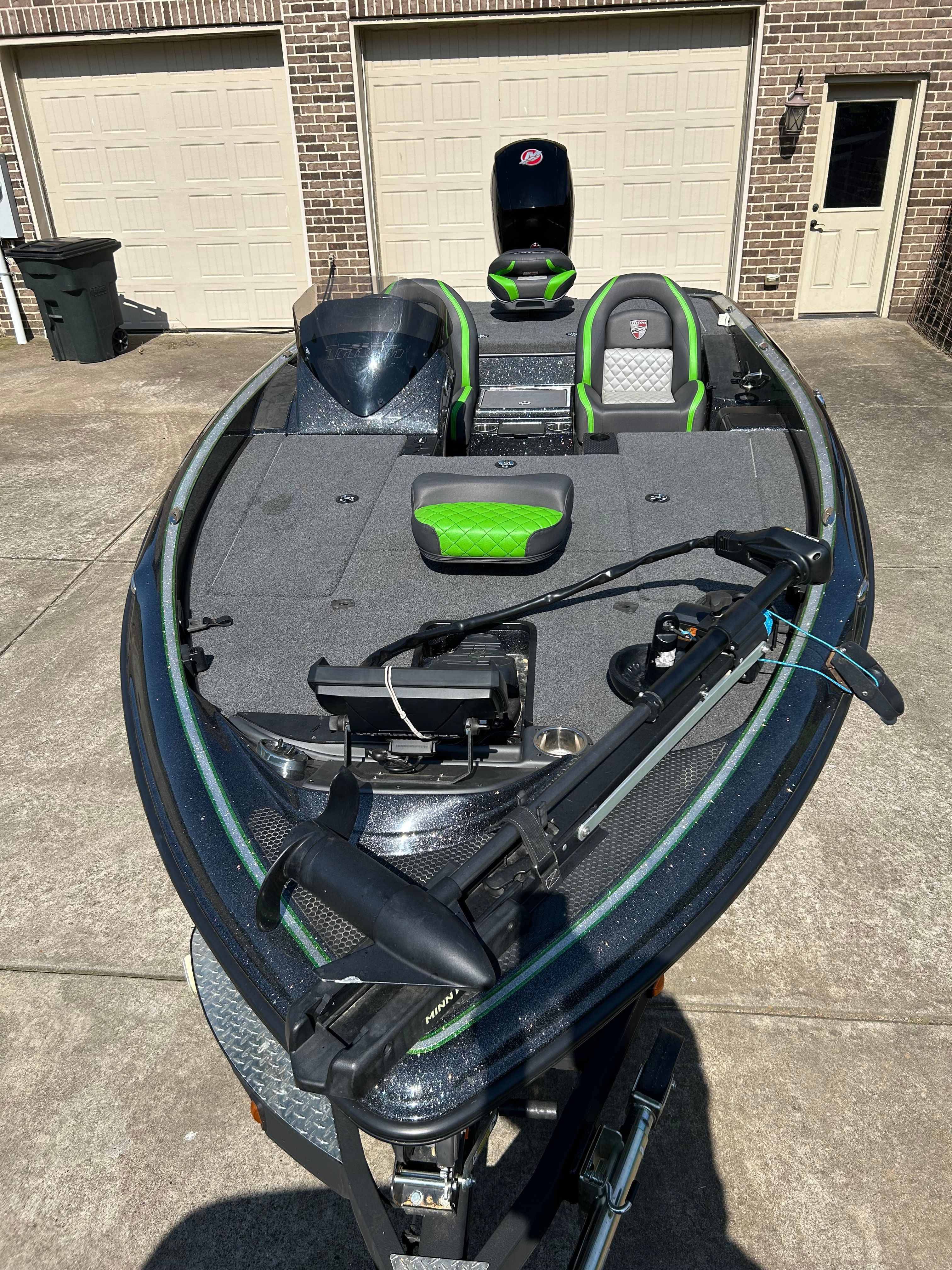 A 2020 Trident 189 TRX boat on a trailer in a driveway.