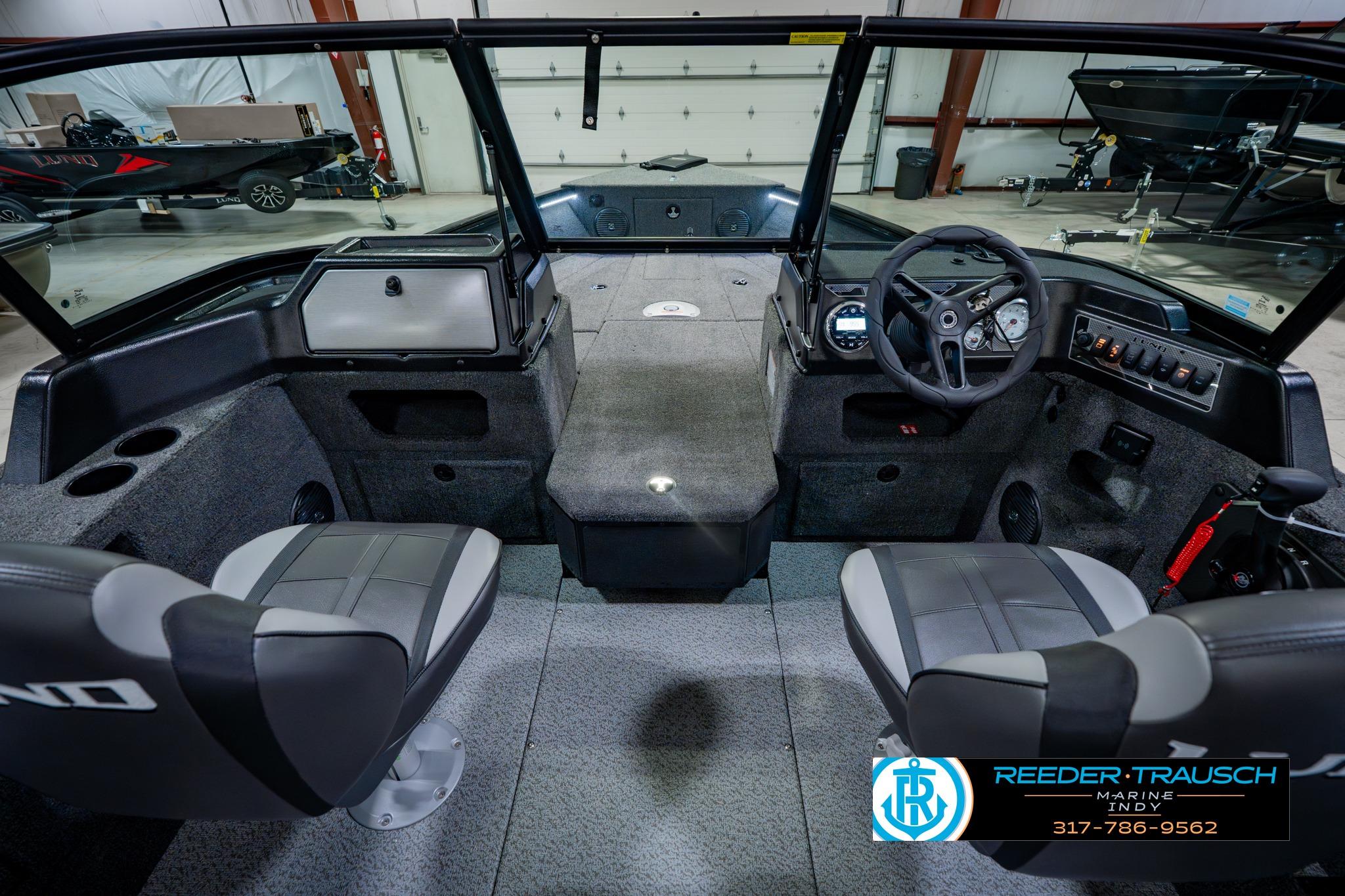 Interior of 2026 Lund 1875 Impact XS boat with steering wheel and seating.