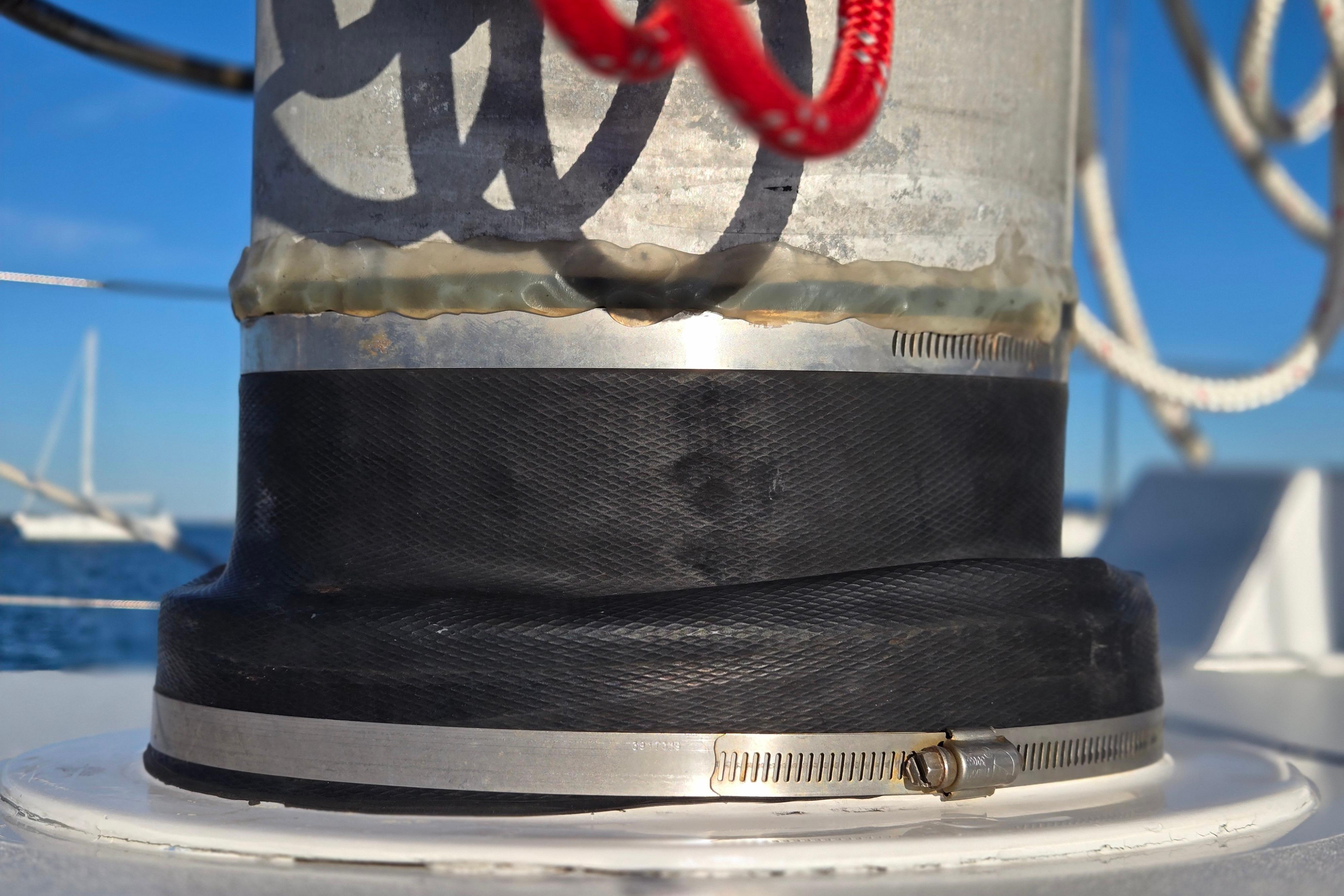 Close-up of a 1970 Hinckley Bermuda 40 sailboat mast detail with clamps and ropes.