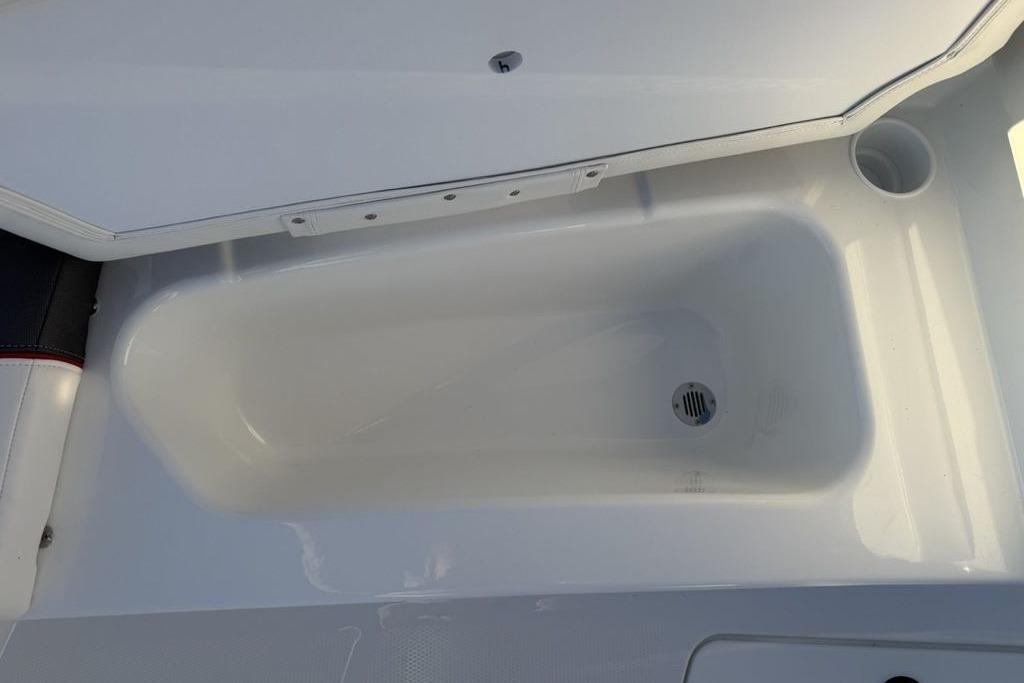 2026 Tahoe T16 boat storage compartment with drain, open lid view.