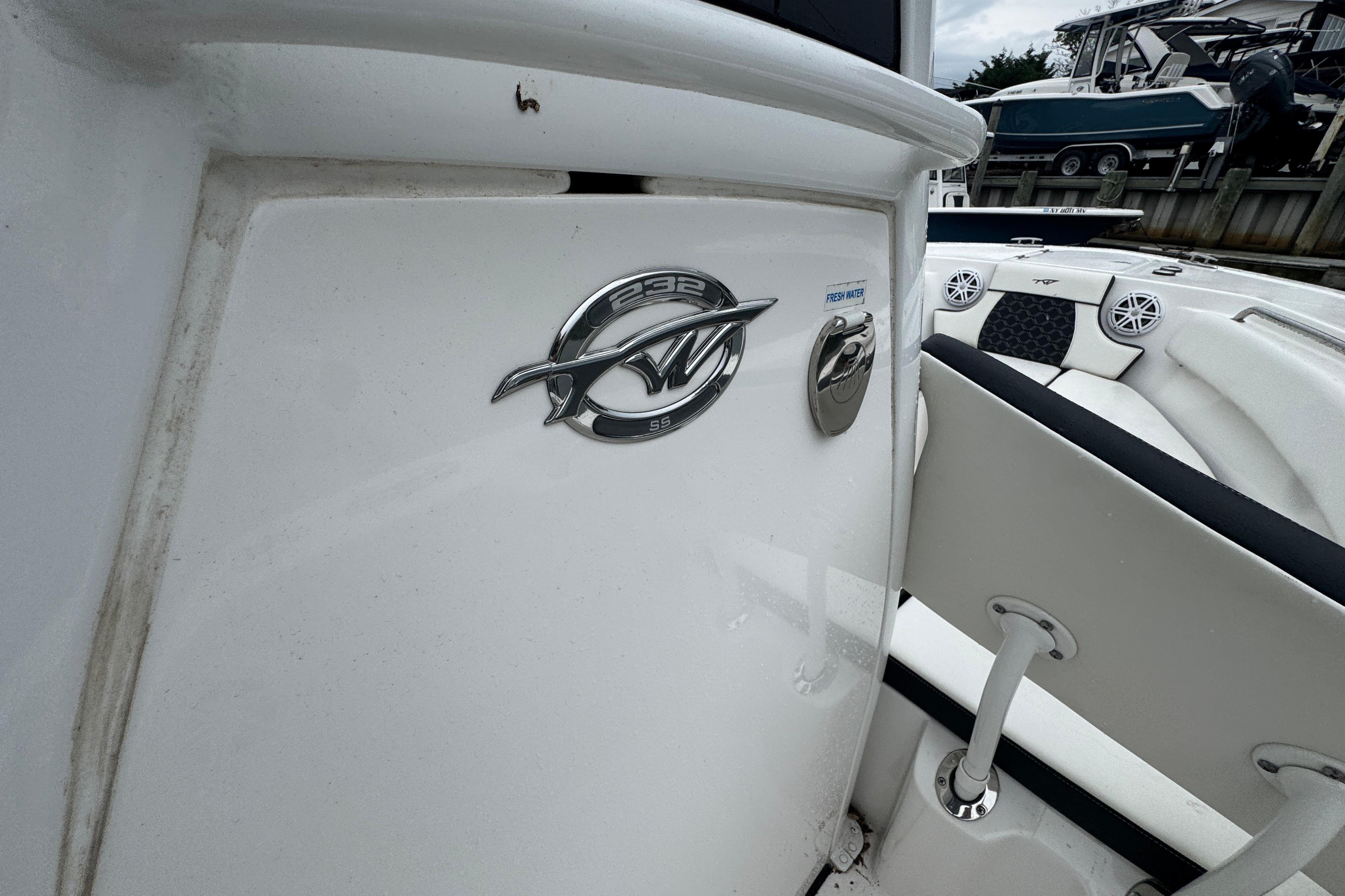 2022 Tidewater 232 SS boat interior with logo and seating details.