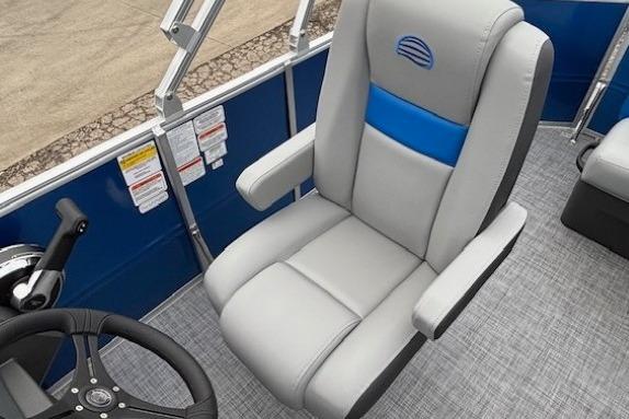 2026 Sun Tracker Party Barge 20 DLX captain's chair and steering wheel, featuring sleek design.