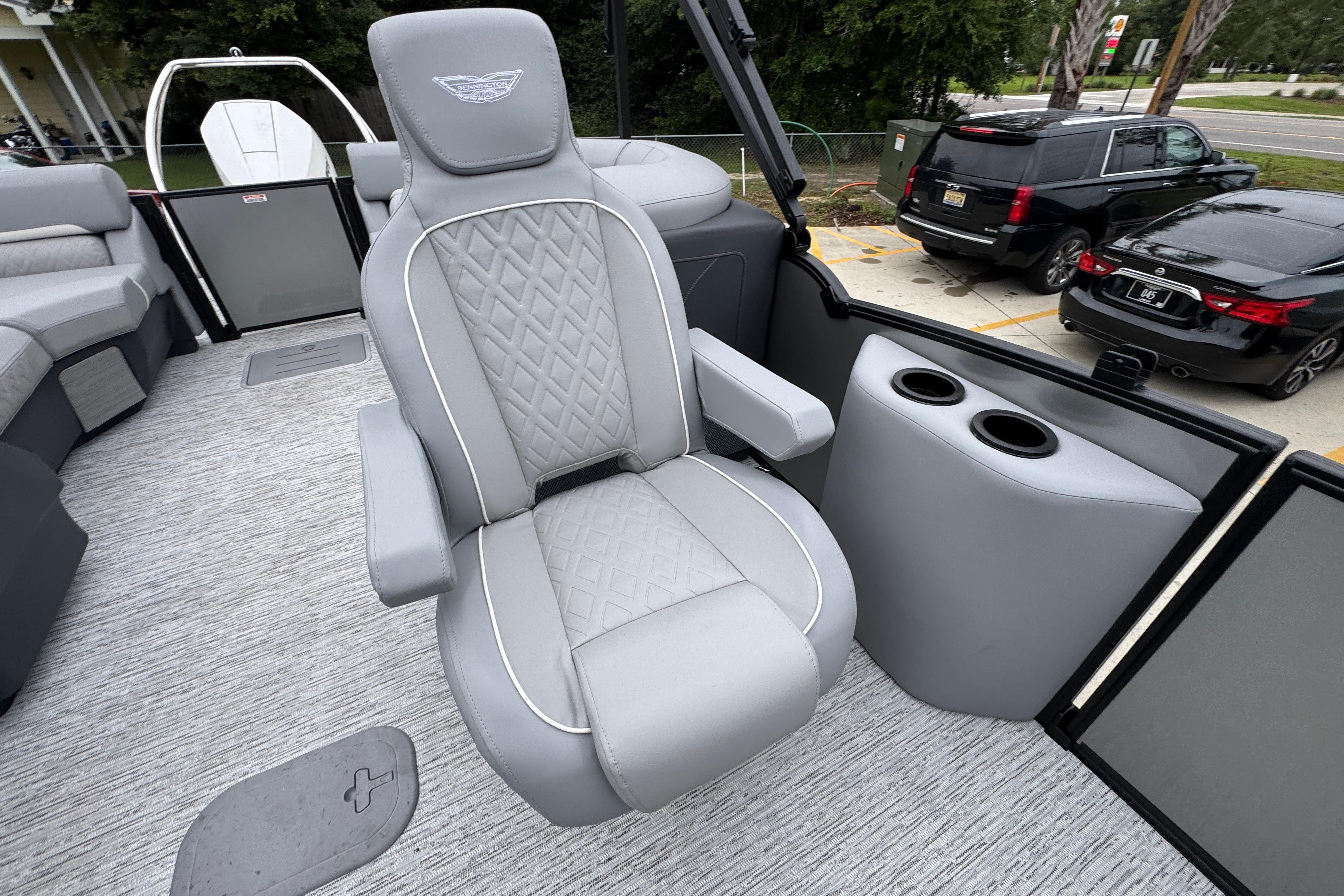 Luxurious seating on a 2027 Bennington 24 MFB boat, featuring elegant gray upholstery.