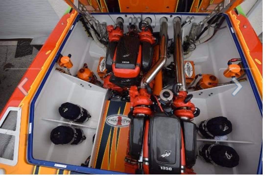 2009 Cigarette 399 Vee boat engine compartment with vibrant orange and black design.