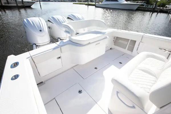 Manufacturer Provided Image: 2026 Jupiter 340LS boat with triple outboard engines, white interior, docked on calm water.